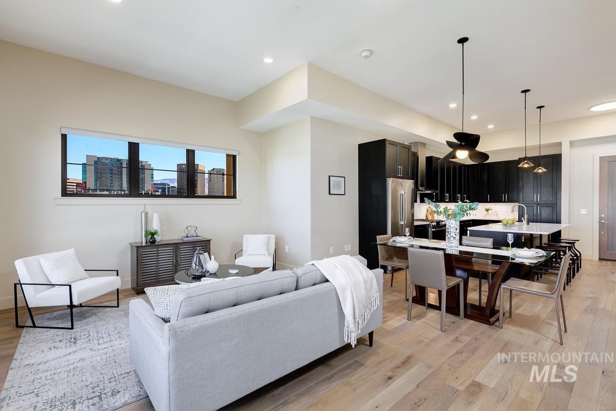 Living area featuring light wood finished floors and recessed lighting