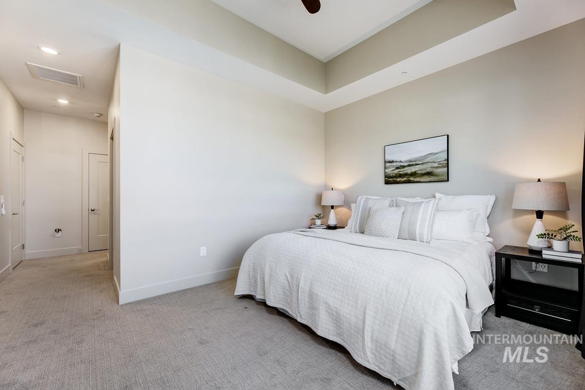 Bedroom with light carpet, recessed lighting, and a ceiling fan