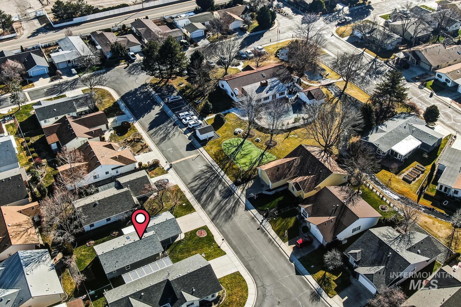 Aerial view of property and surrounding area featuring nearby suburban area