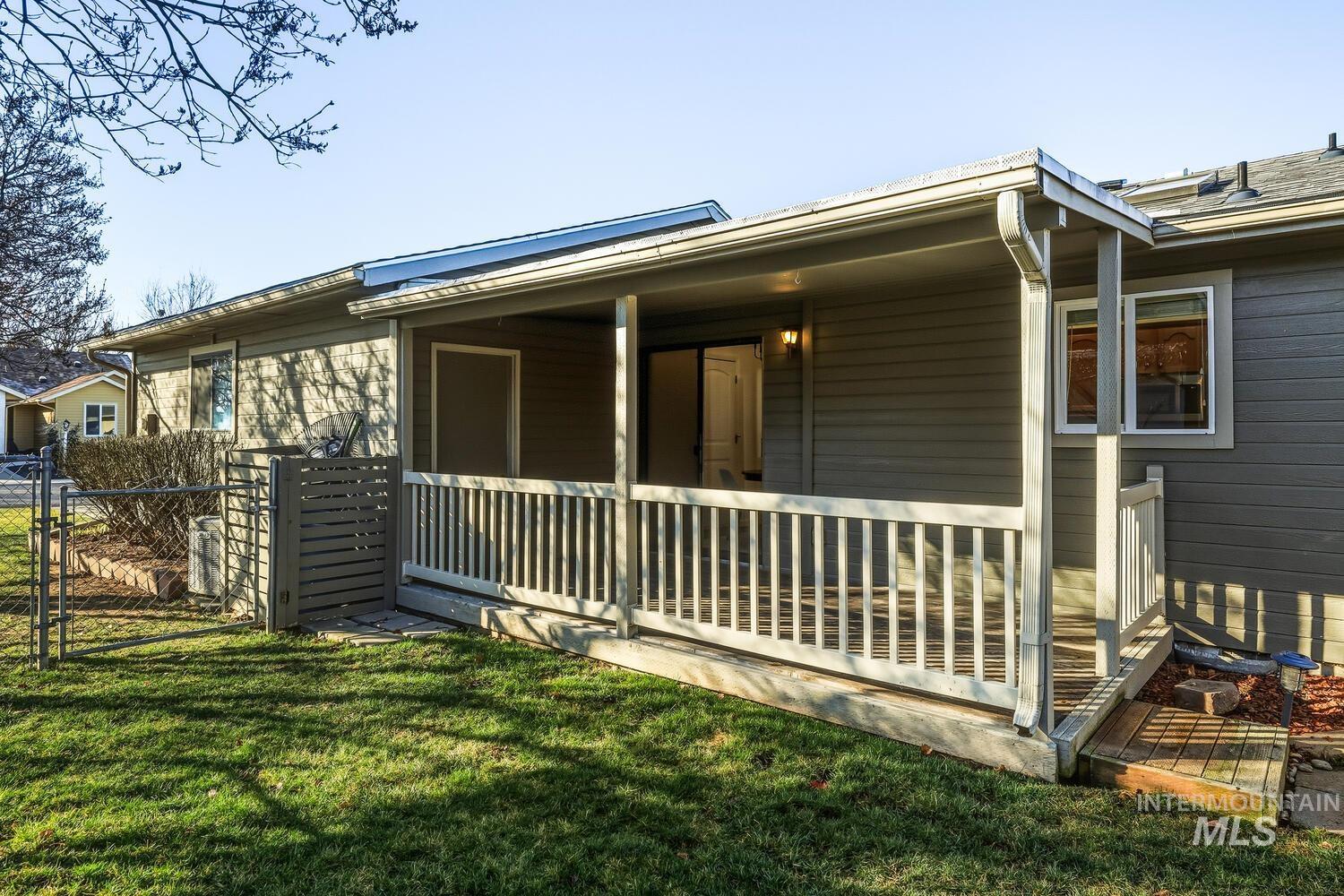 View of side of home featuring a gate