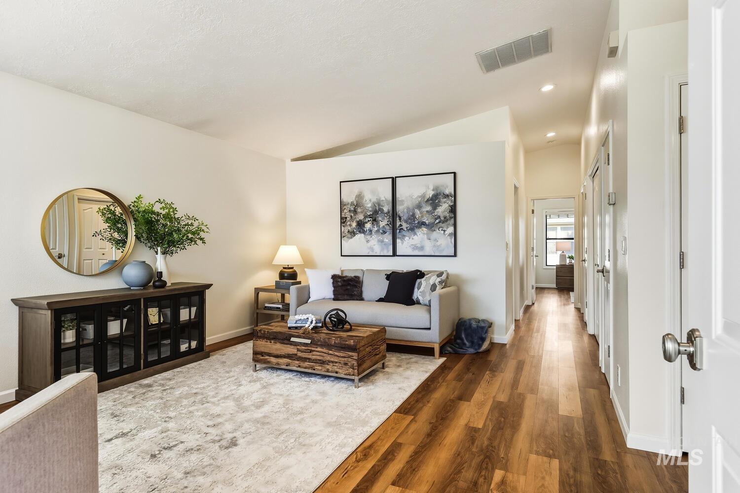 Living room with dark wood-style flooring, recessed lighting, and lofted ceiling