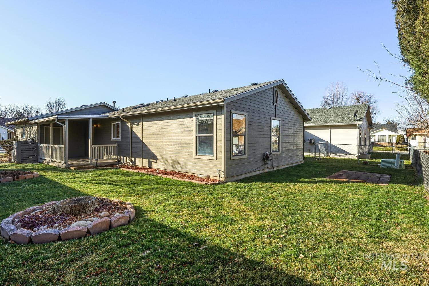 Rear view of property featuring an outdoor fire pit and a wooden deck