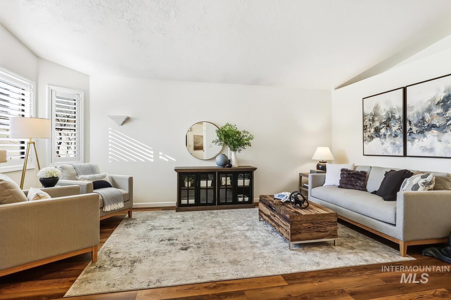 Living room with wood finished floors and a textured ceiling