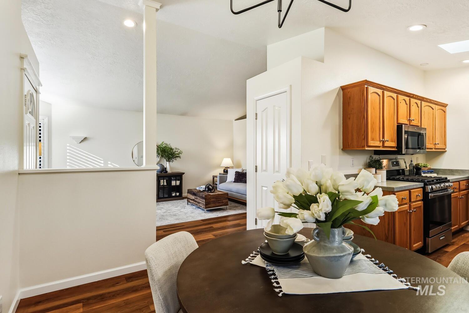 Dining space featuring dark wood finished floors and recessed lighting