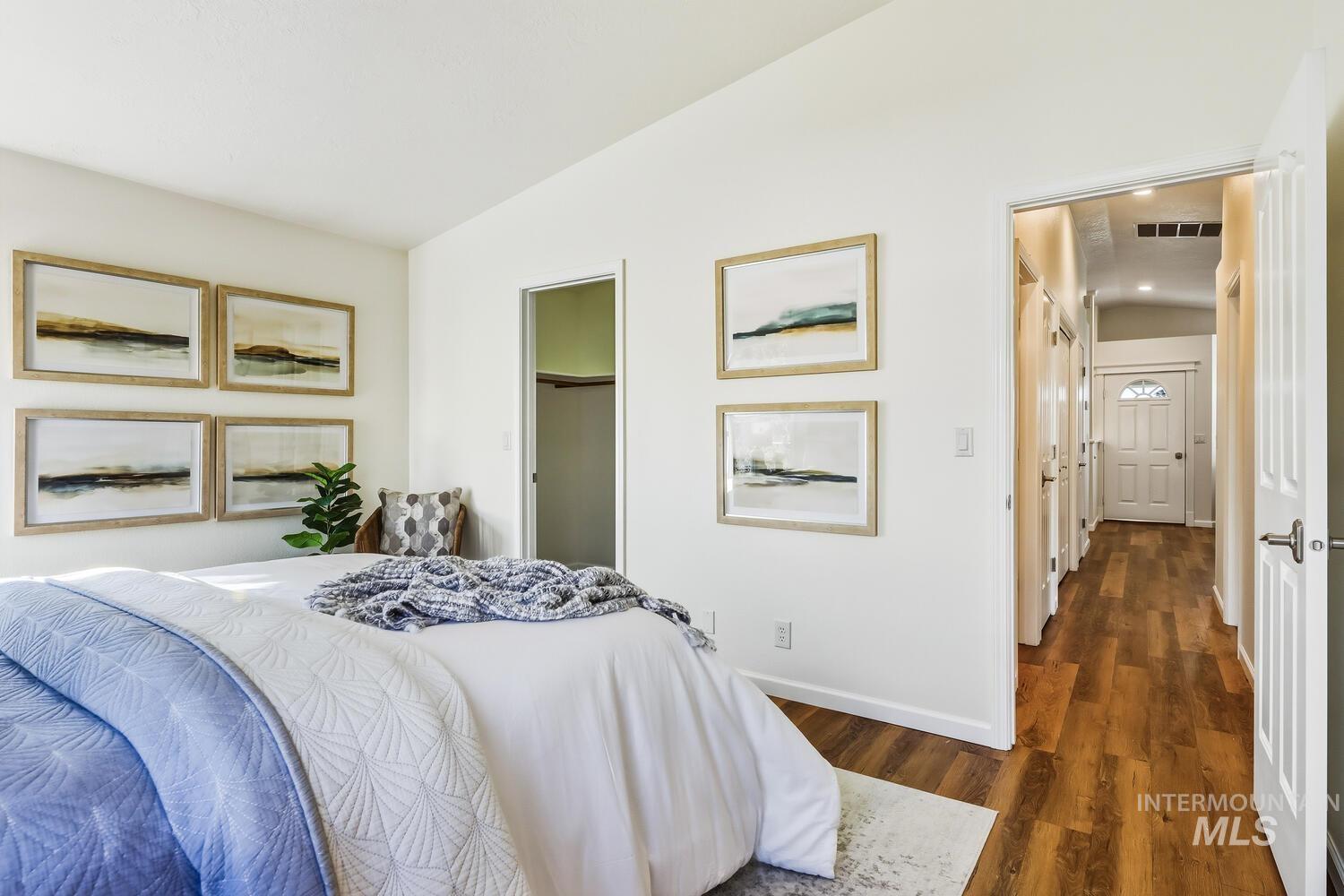 Bedroom featuring lofted ceiling and dark wood finished floors