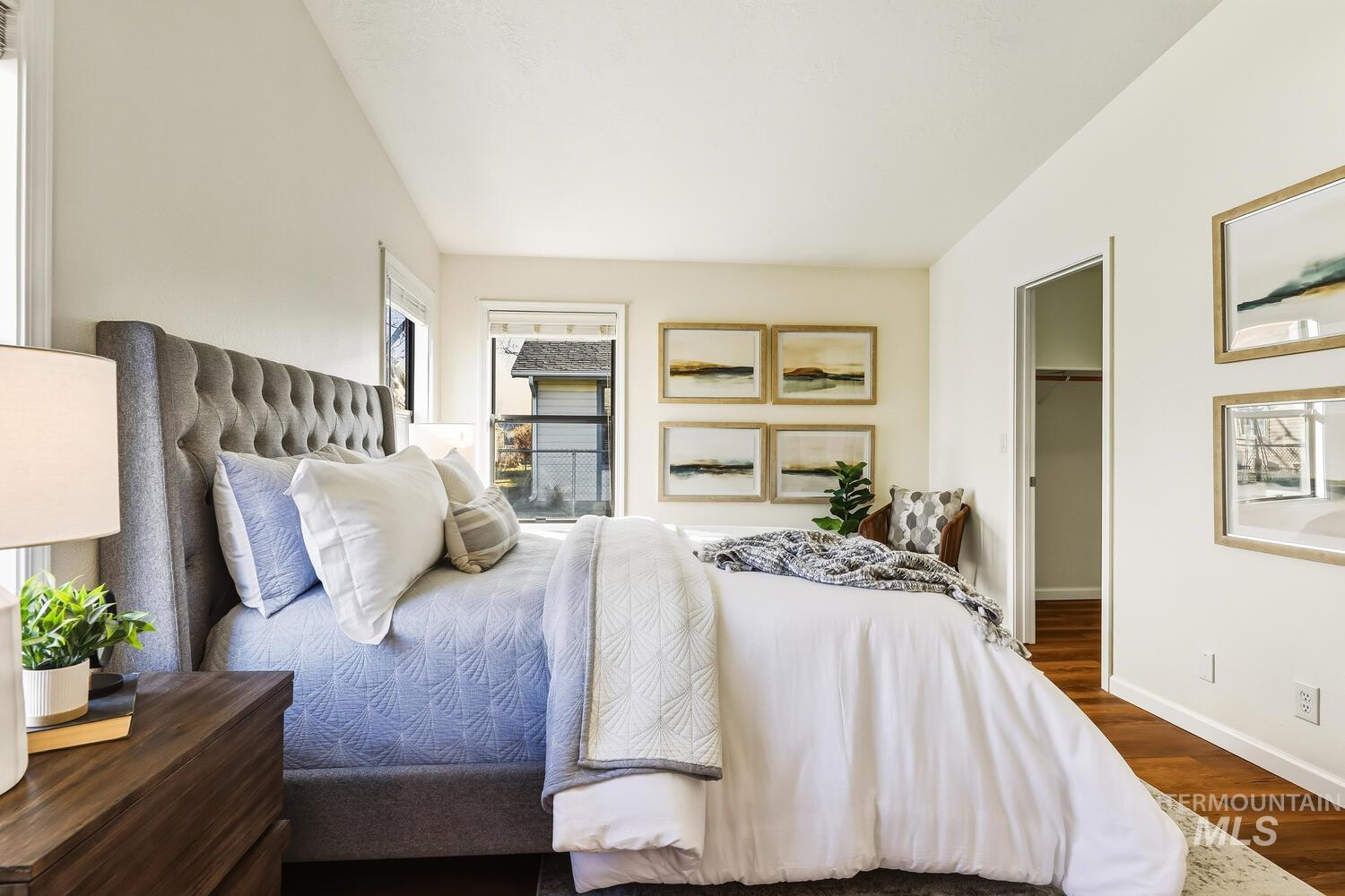 Bedroom featuring a spacious closet and wood finished floors