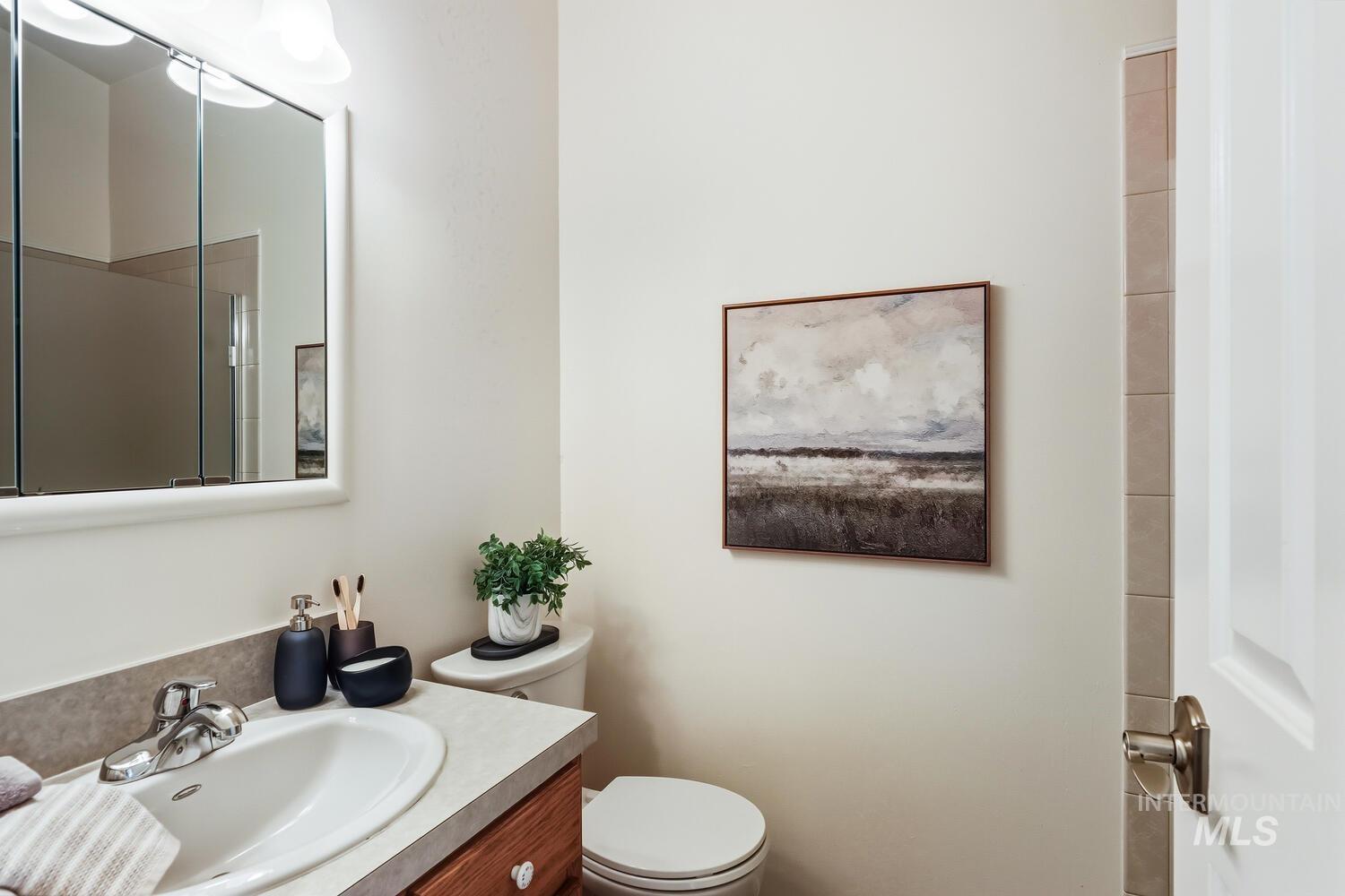 Full bathroom featuring vanity and toilet
