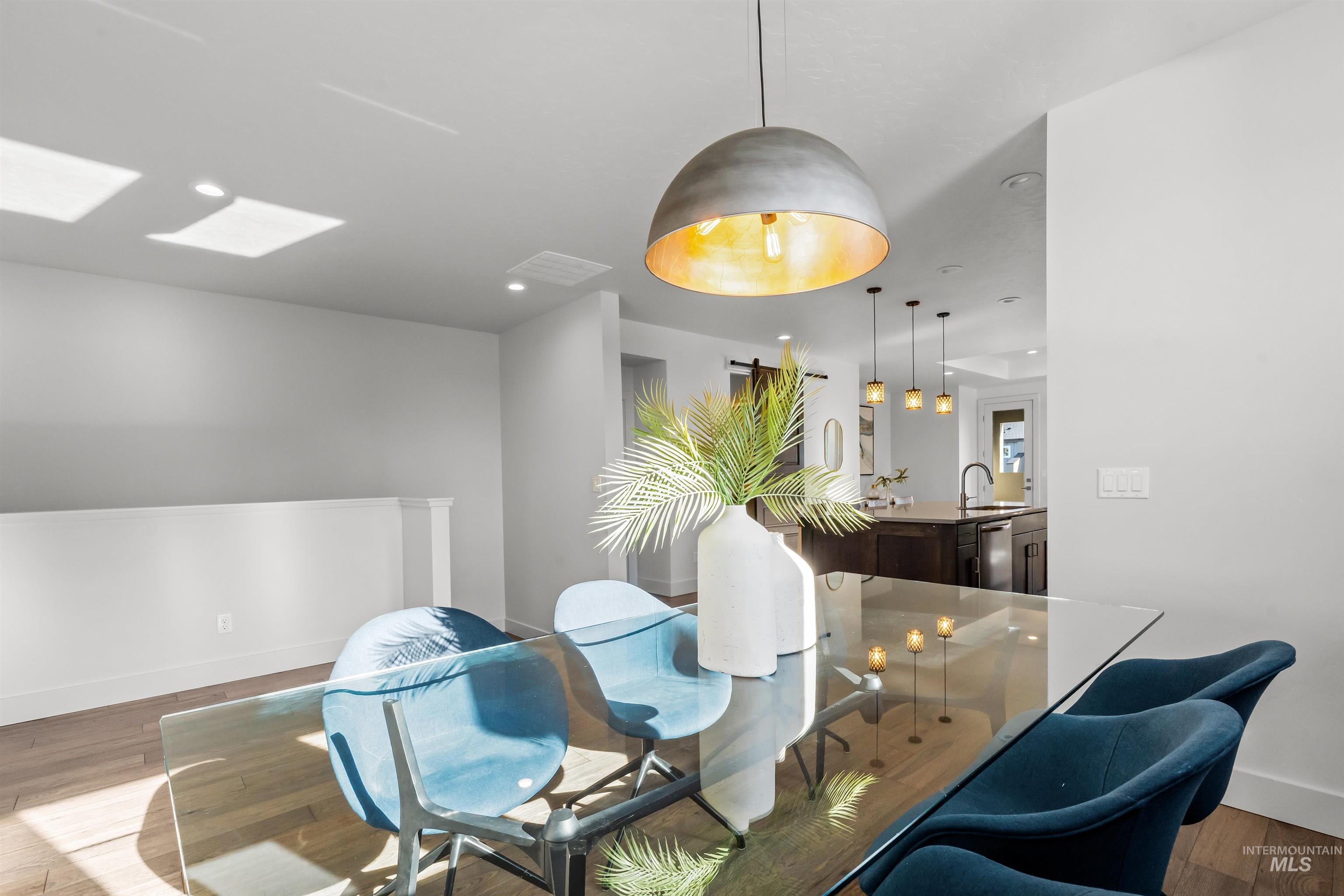 Dining space with wood finished floors and baseboards