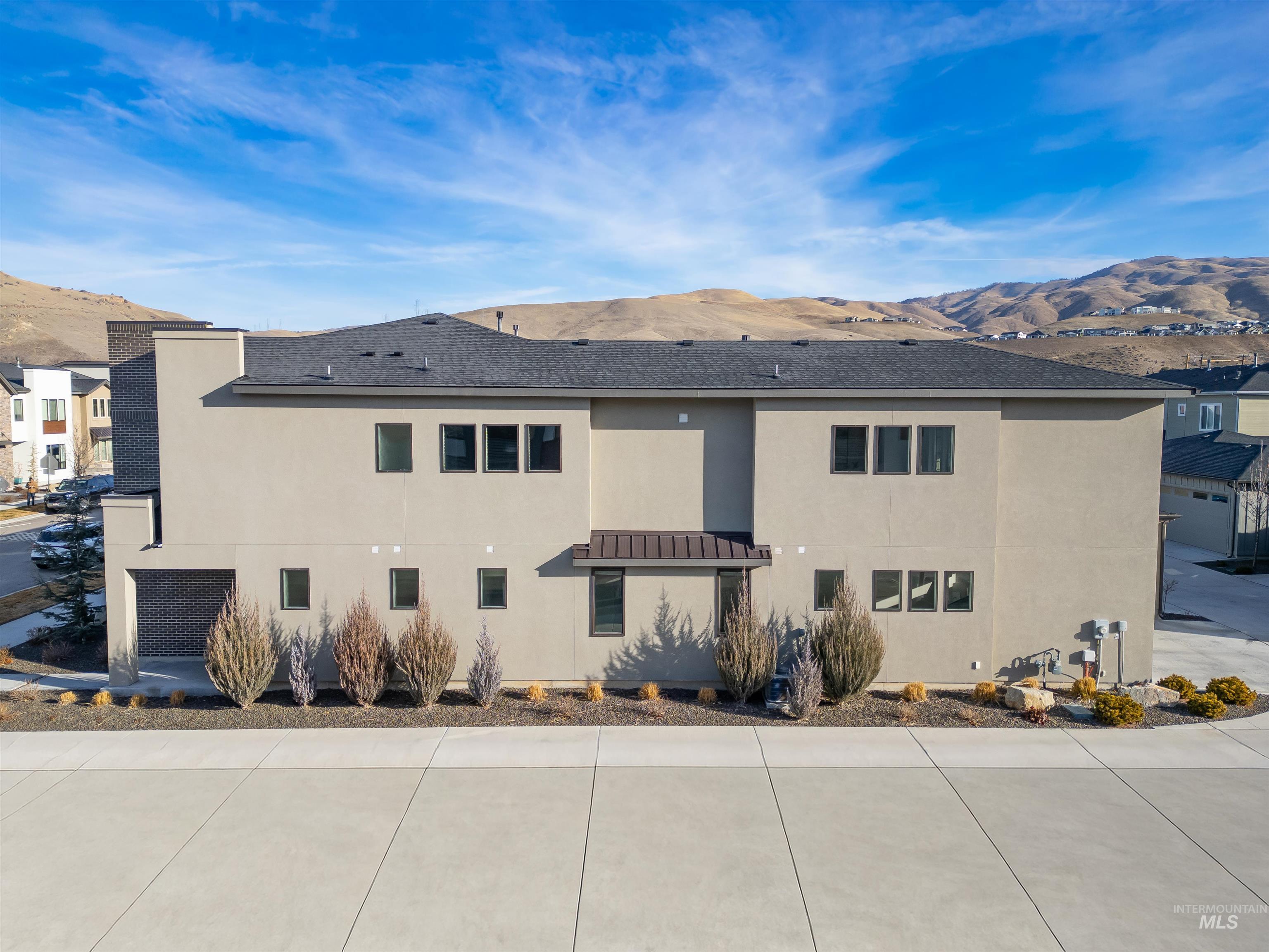 View of side of home featuring a mountain view and stucco siding