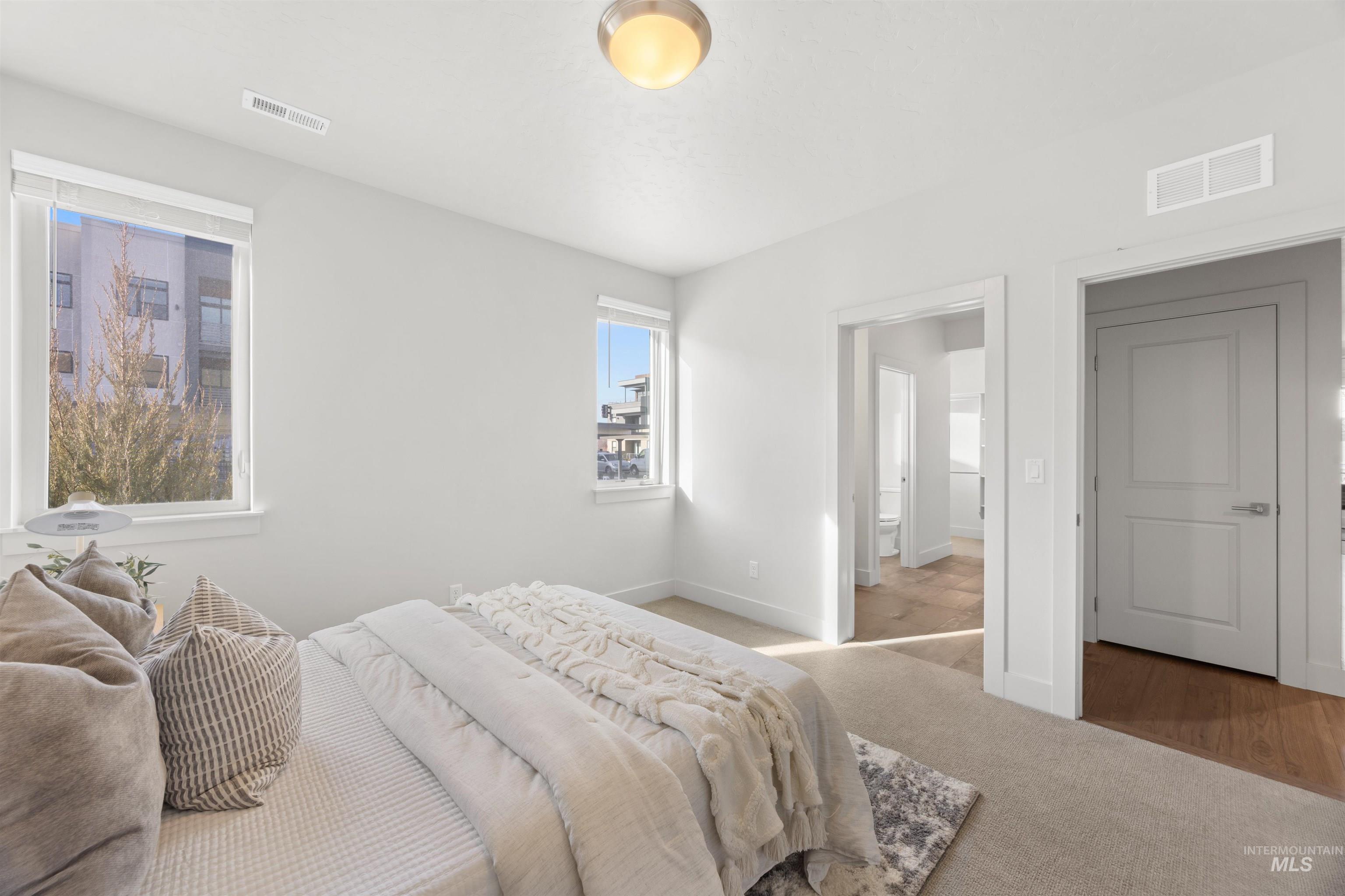 Carpeted bedroom with baseboards