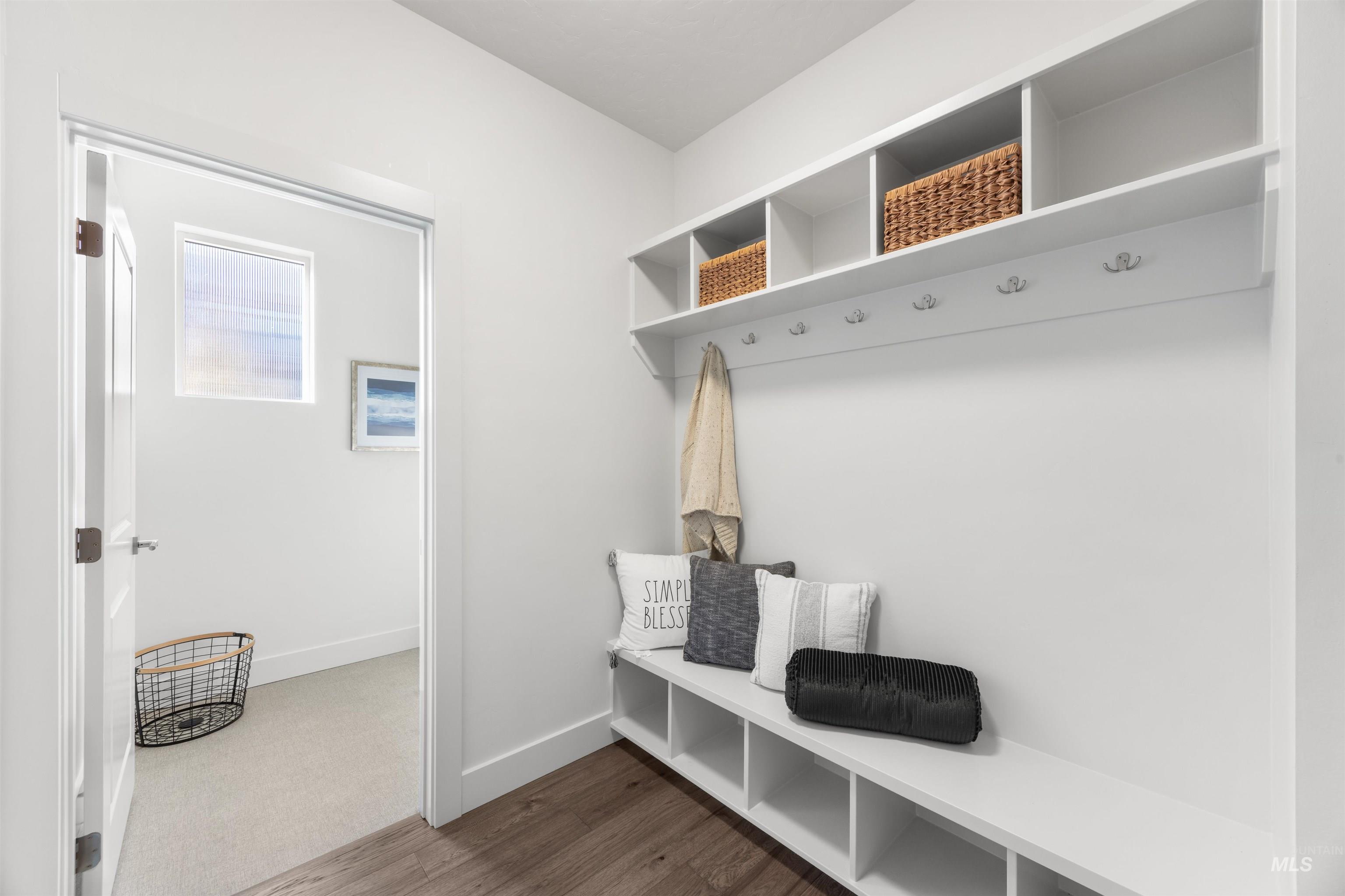 Mudroom featuring baseboards and dark wood-style flooring