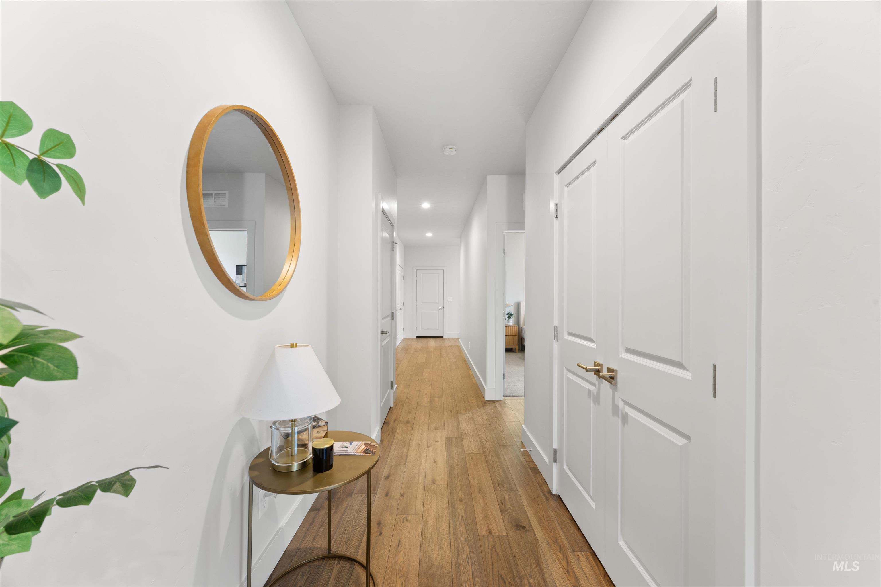 Hall with recessed lighting and light wood-type flooring