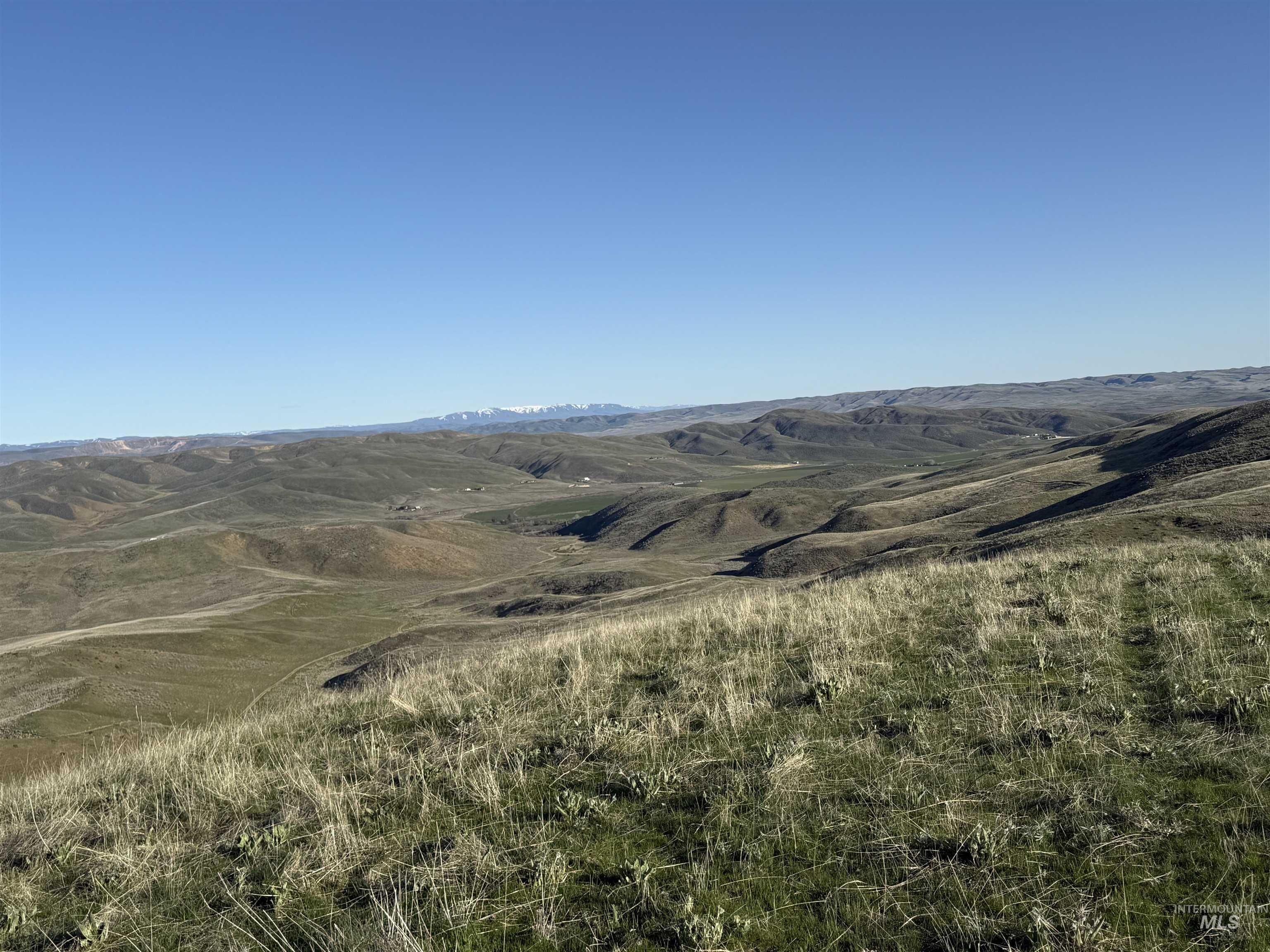 View of mountain backdrop featuring rural landscape