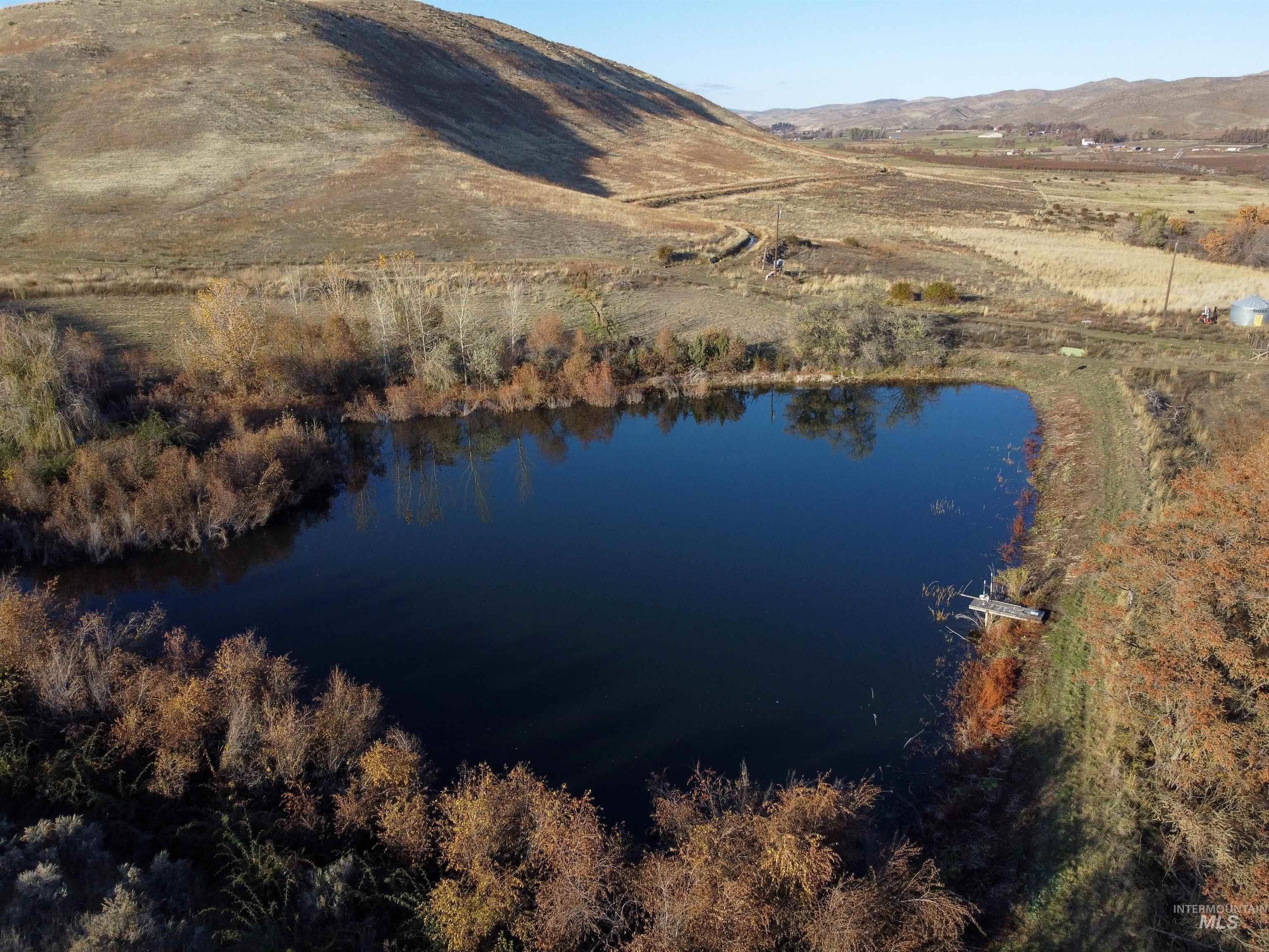 Aerial view of property and surrounding area with a water and mountain view