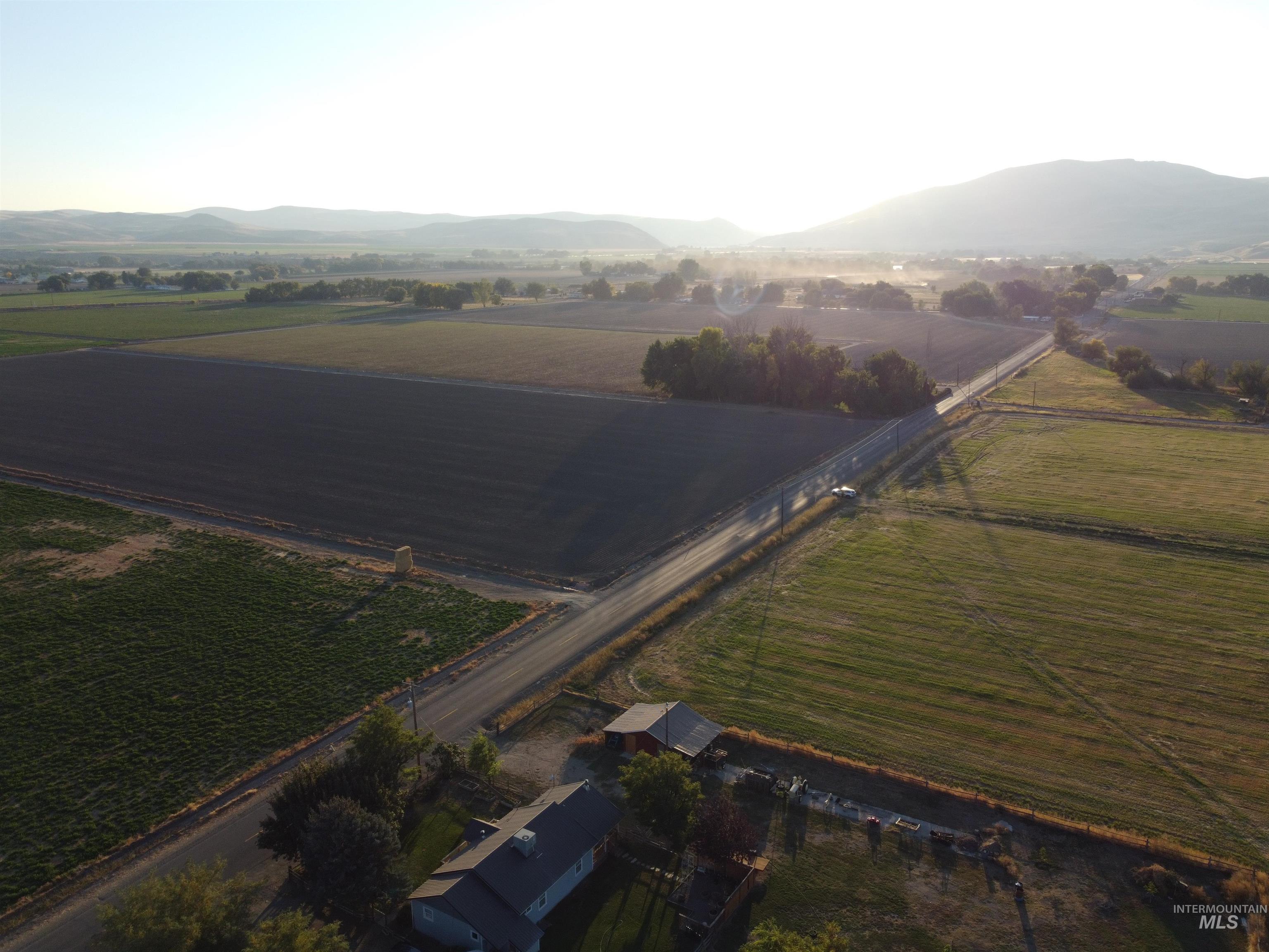 Aerial overview of property's location featuring rural landscape and a mountainous background