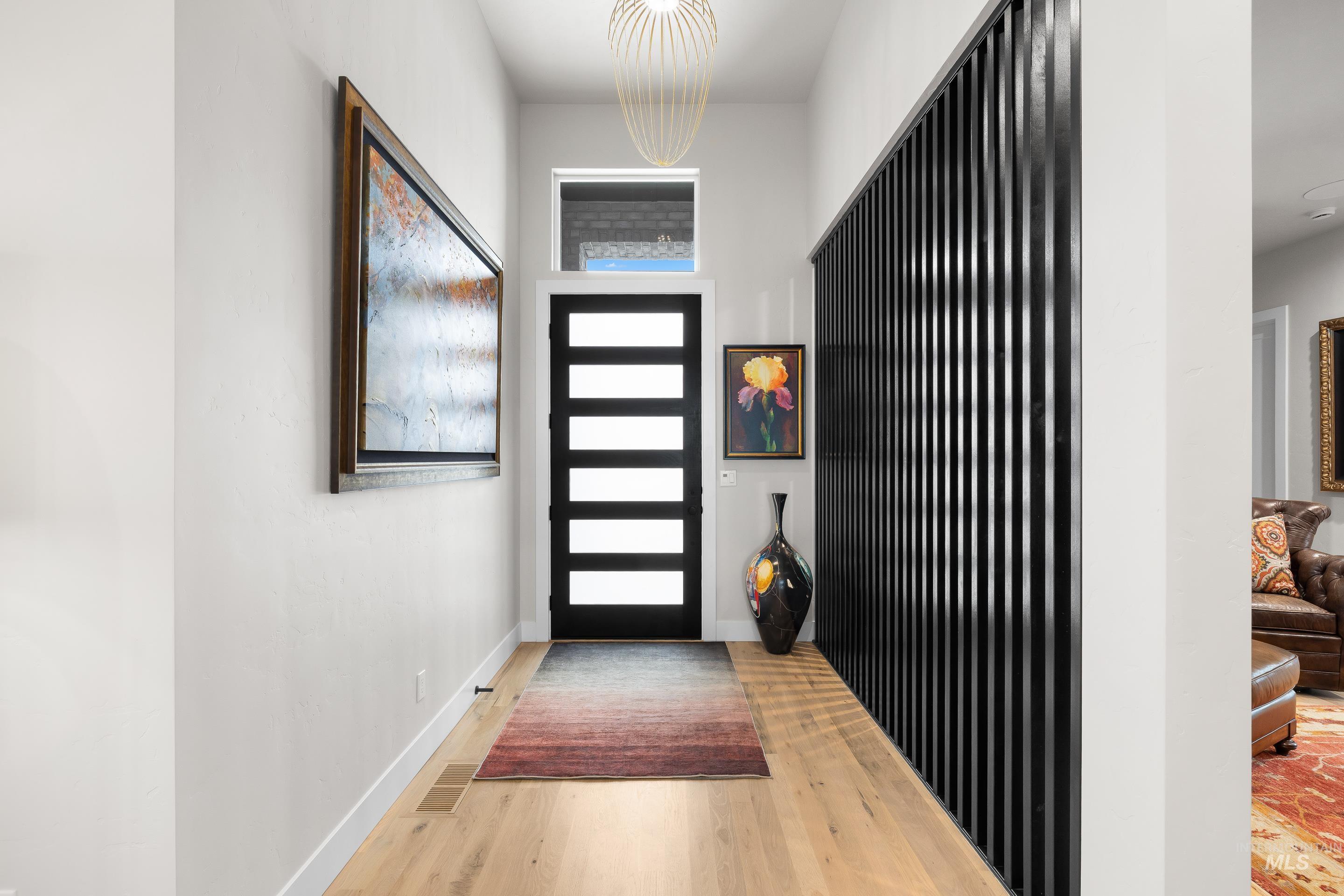 Entryway featuring baseboards and light wood finished floors