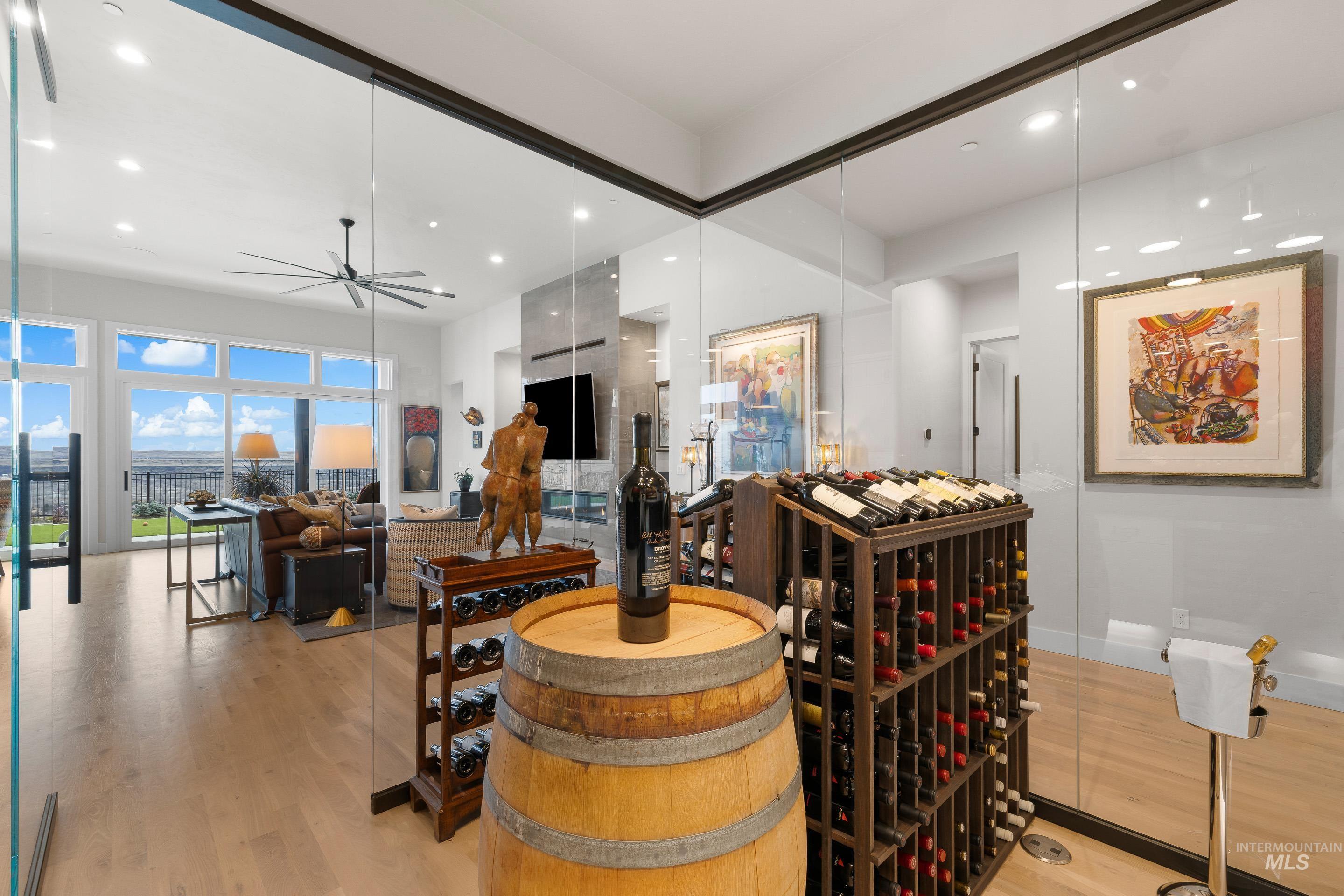 Wine room with light wood-type flooring, recessed lighting, and a ceiling fan