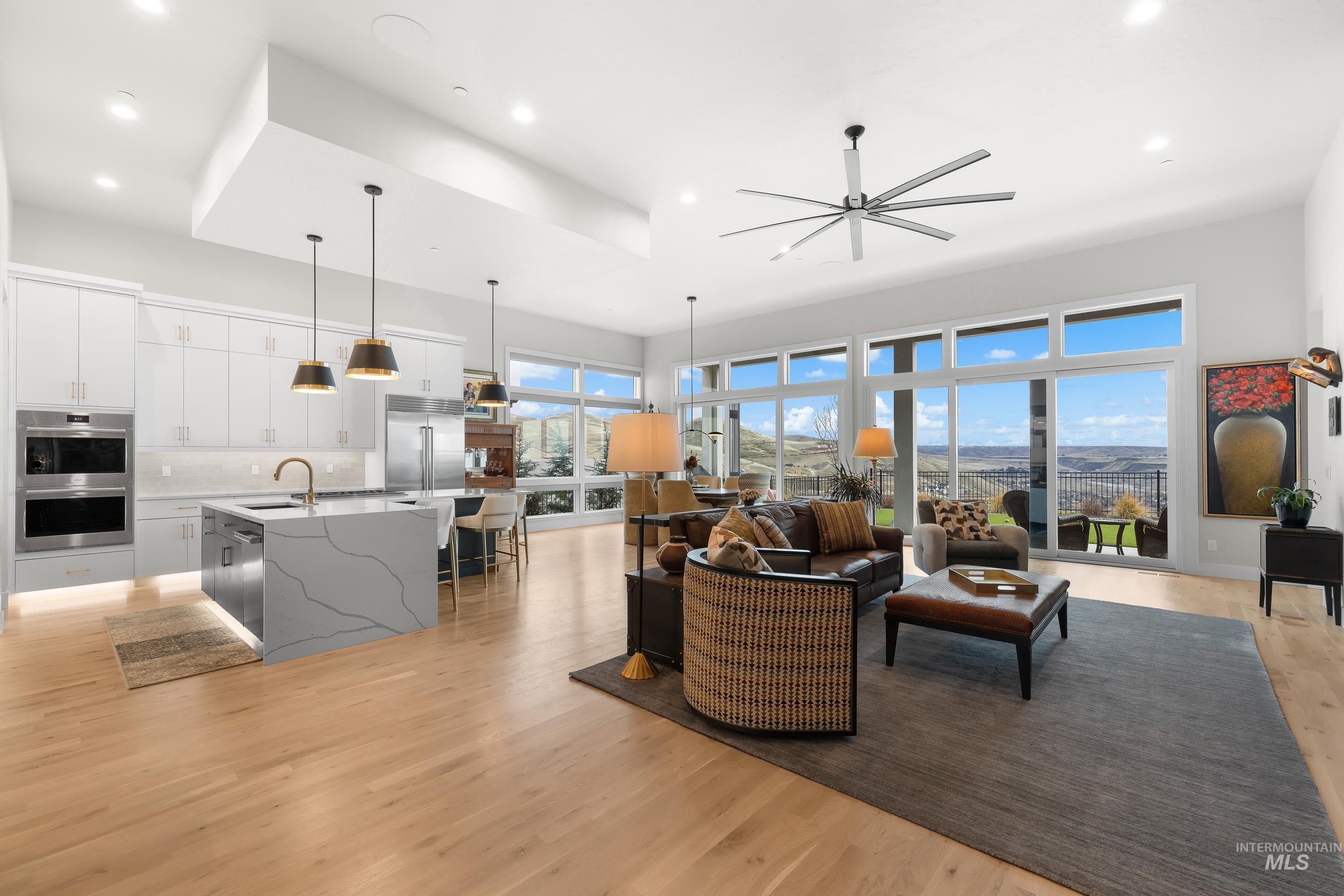 Living area with ceiling fan, light wood-type flooring, and recessed lighting