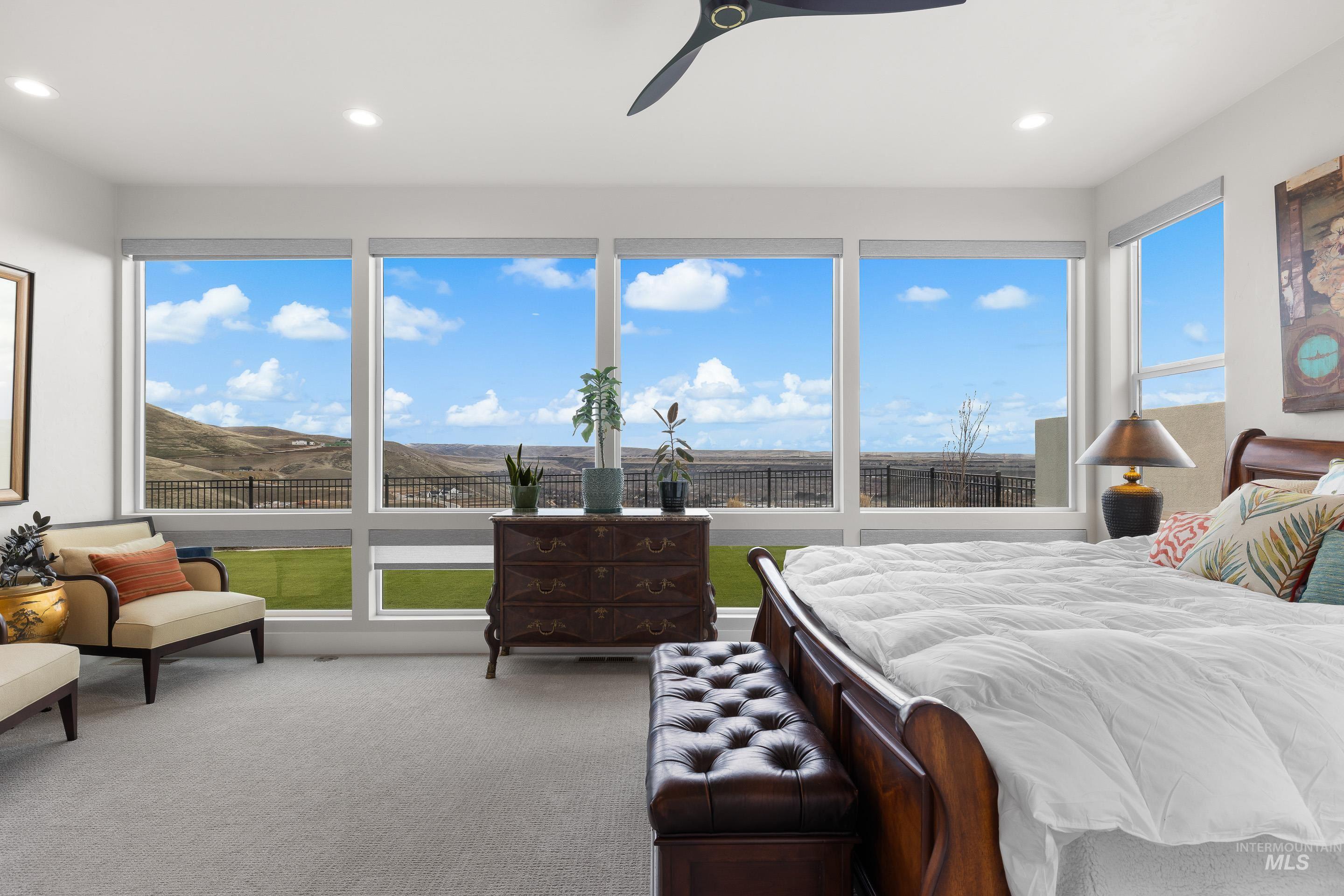 Bedroom with light carpet, ceiling fan, and recessed lighting