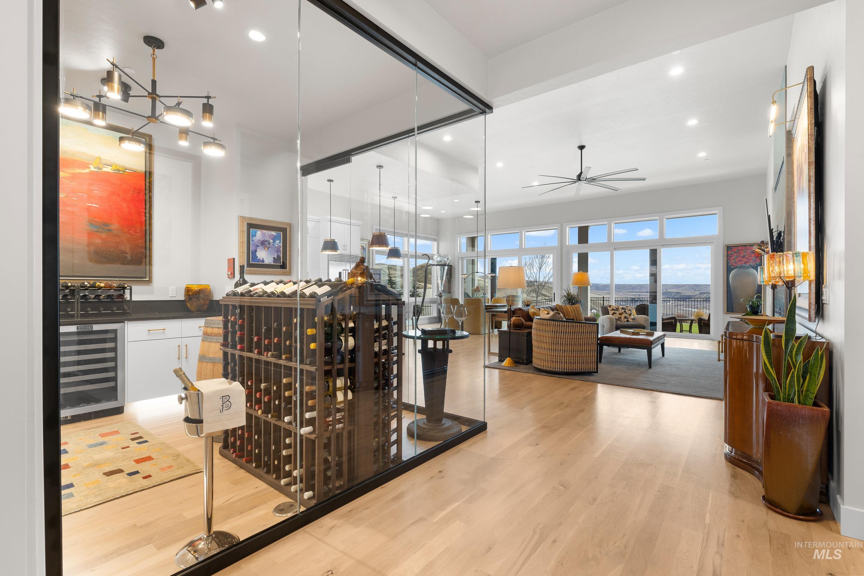 Wine area featuring light wood-style flooring, wine cooler, a dry bar, recessed lighting, and ceiling fan
