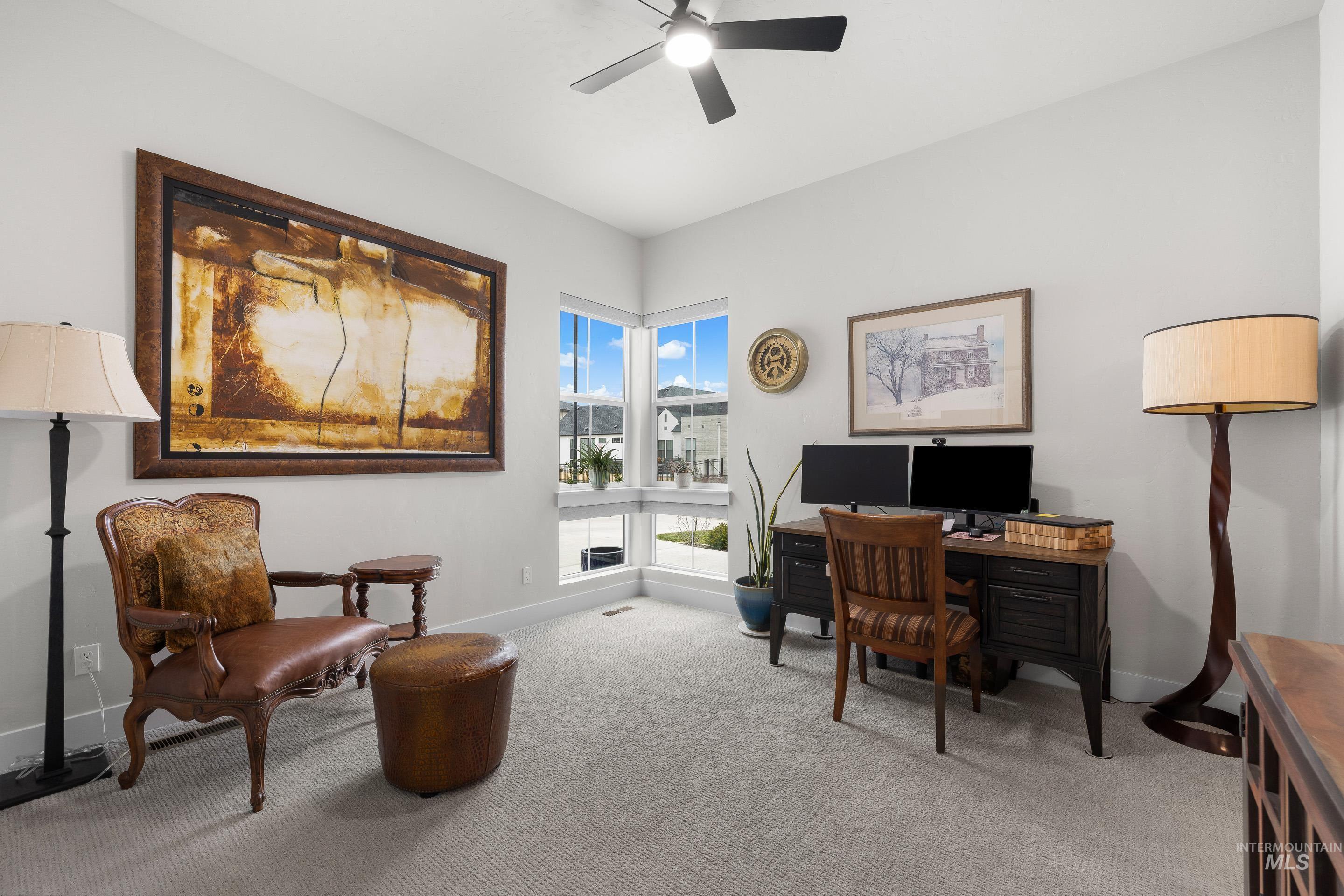 Office area with carpet and a ceiling fan