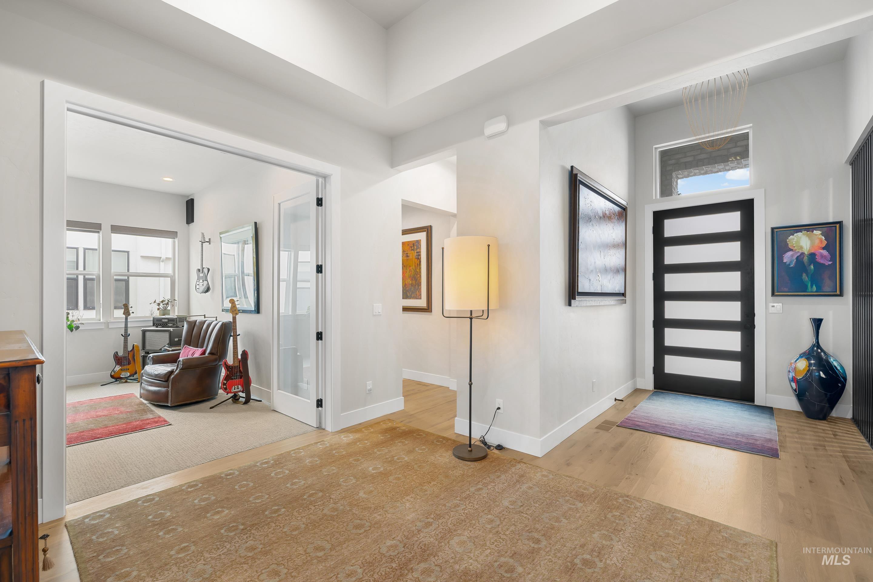 Entrance foyer with baseboards and wood finished floors