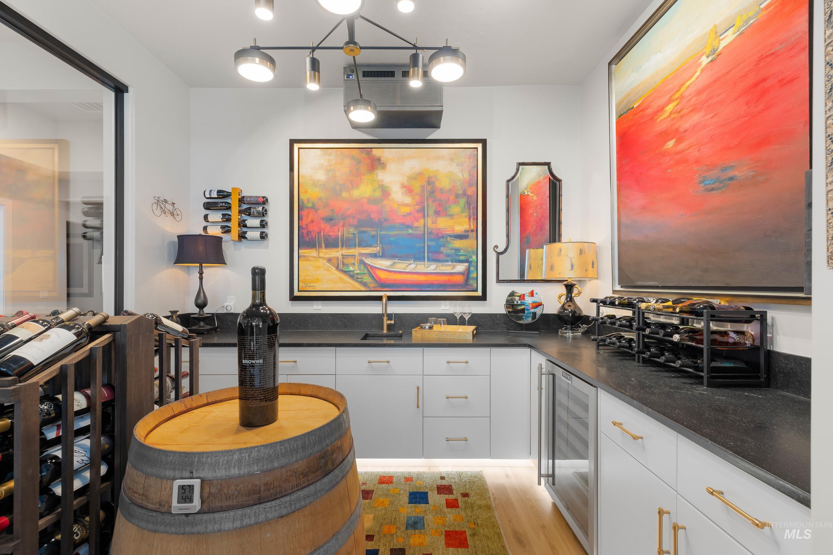 Office with beverage cooler and light wood finished floors