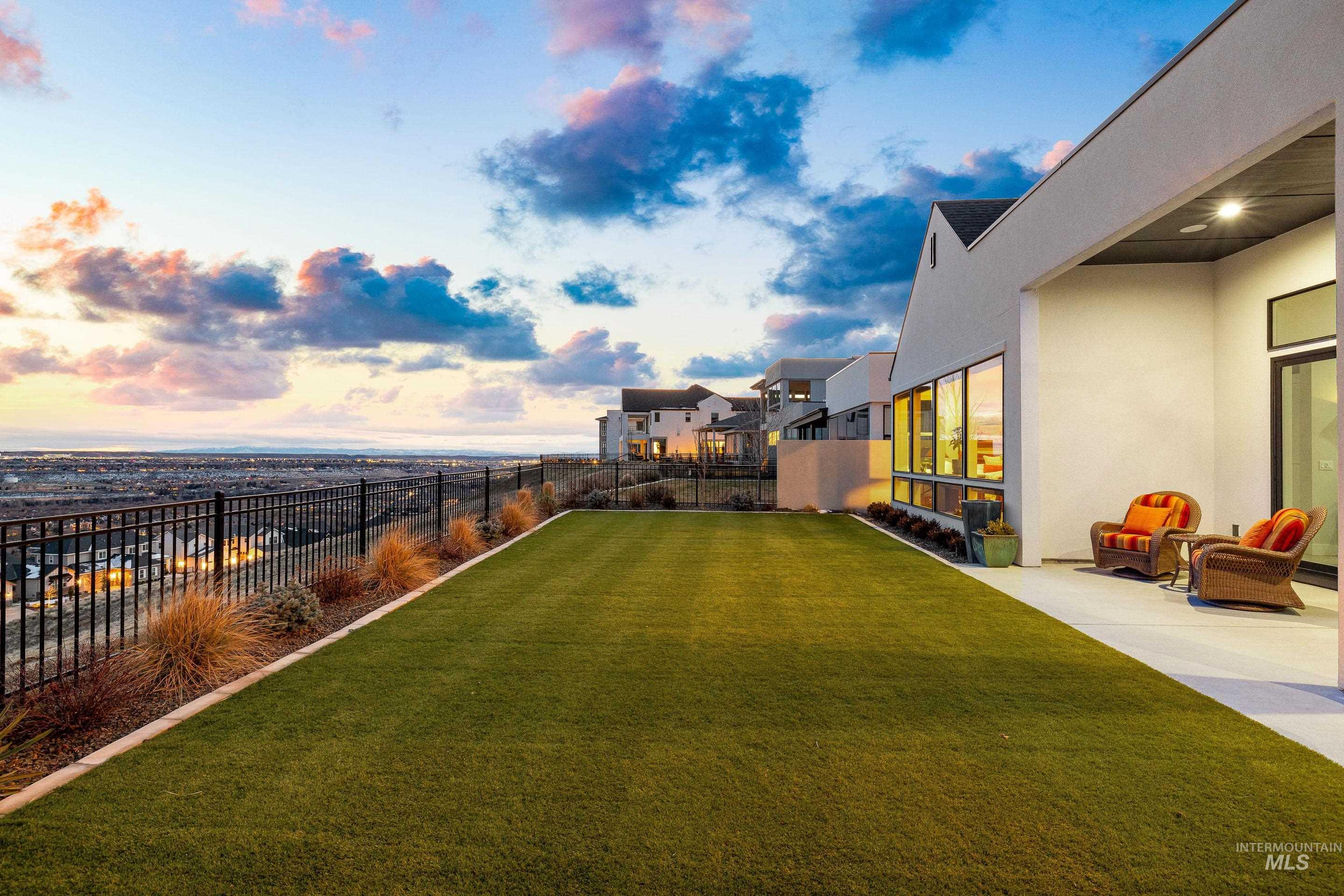 Yard at dusk featuring a patio