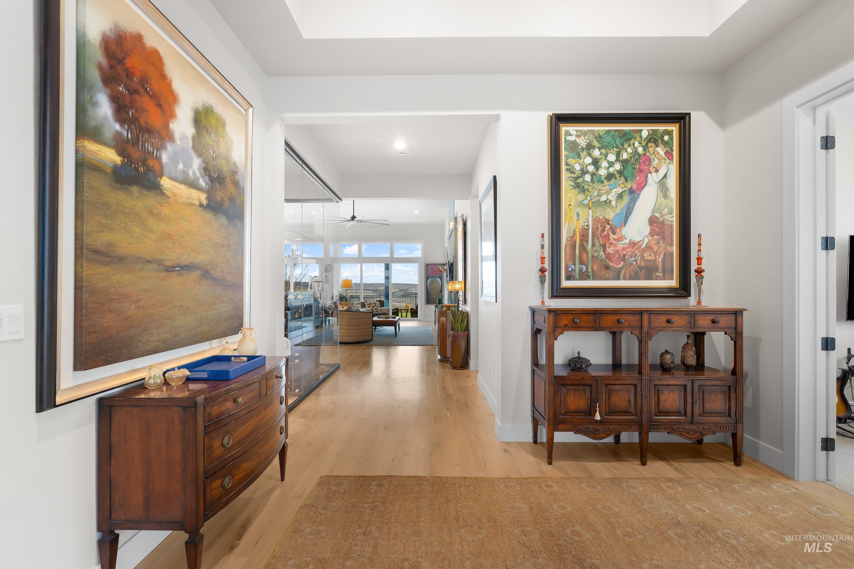 Hall featuring light wood finished floors and recessed lighting