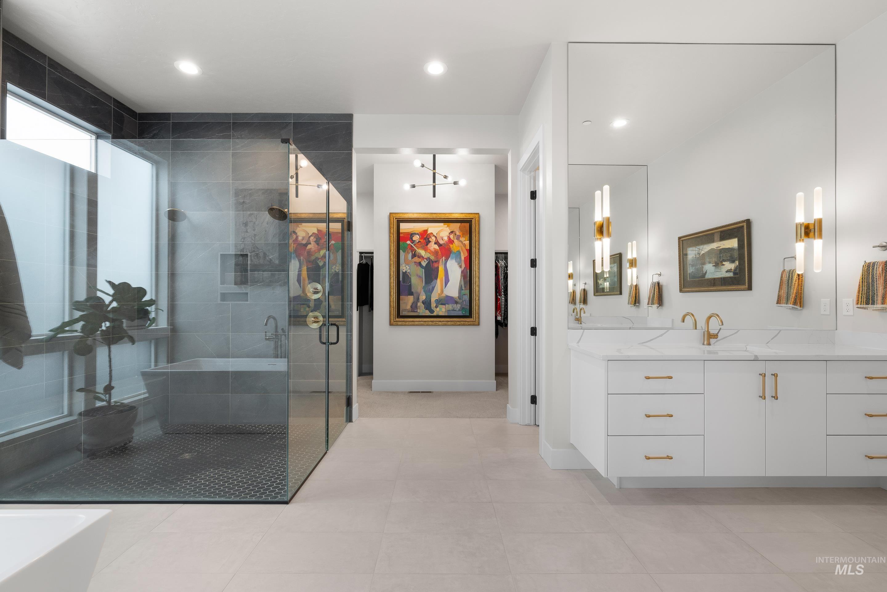Full bath featuring vanity, a freestanding bath, a shower stall, recessed lighting, and light tile patterned flooring