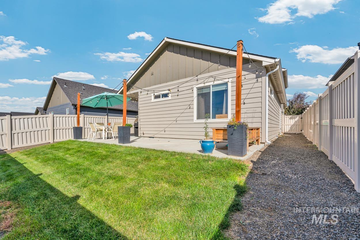 Rear view of property featuring a fenced backyard, a patio area, and board and batten siding