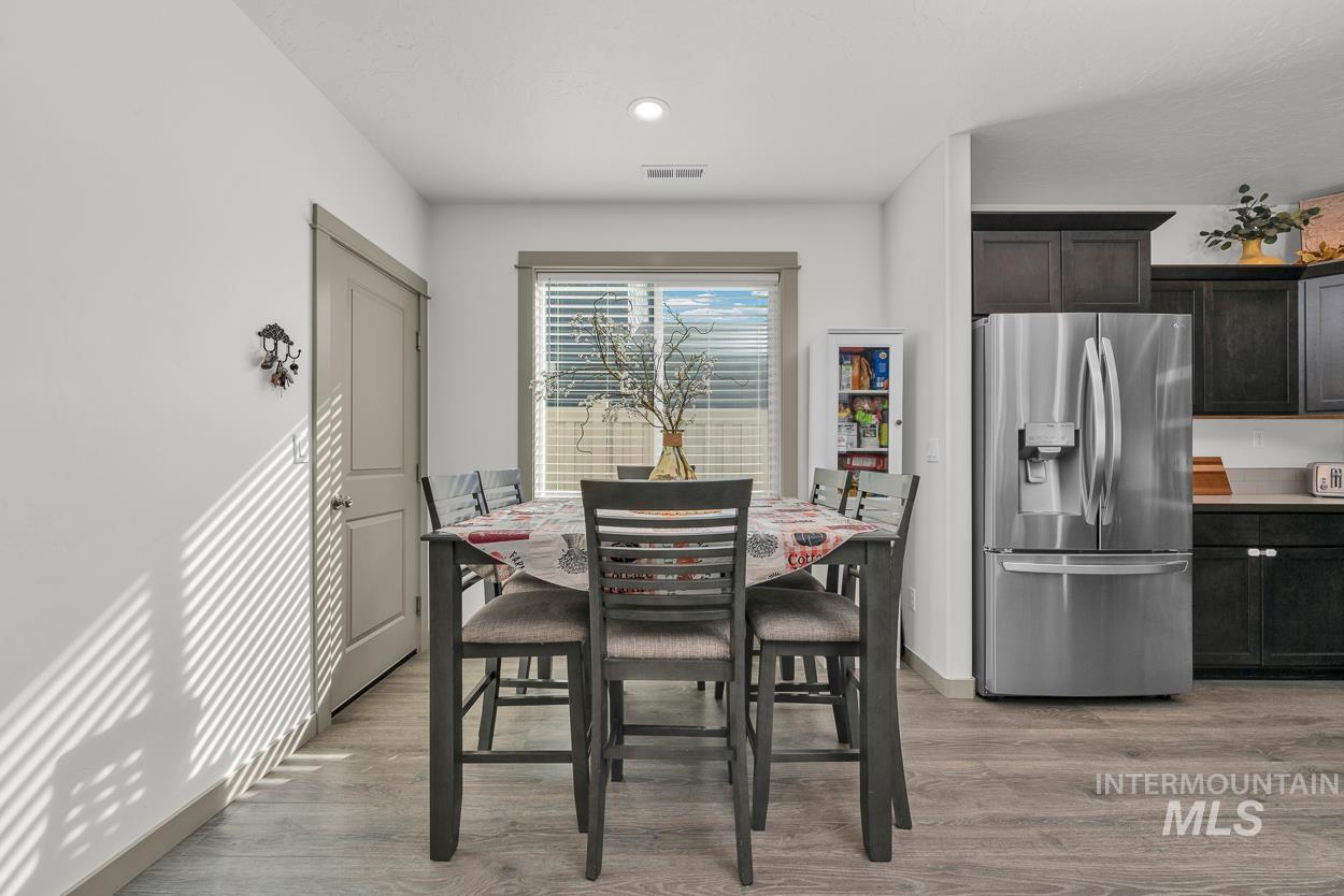 Dining area featuring light wood-style flooring and recessed lighting