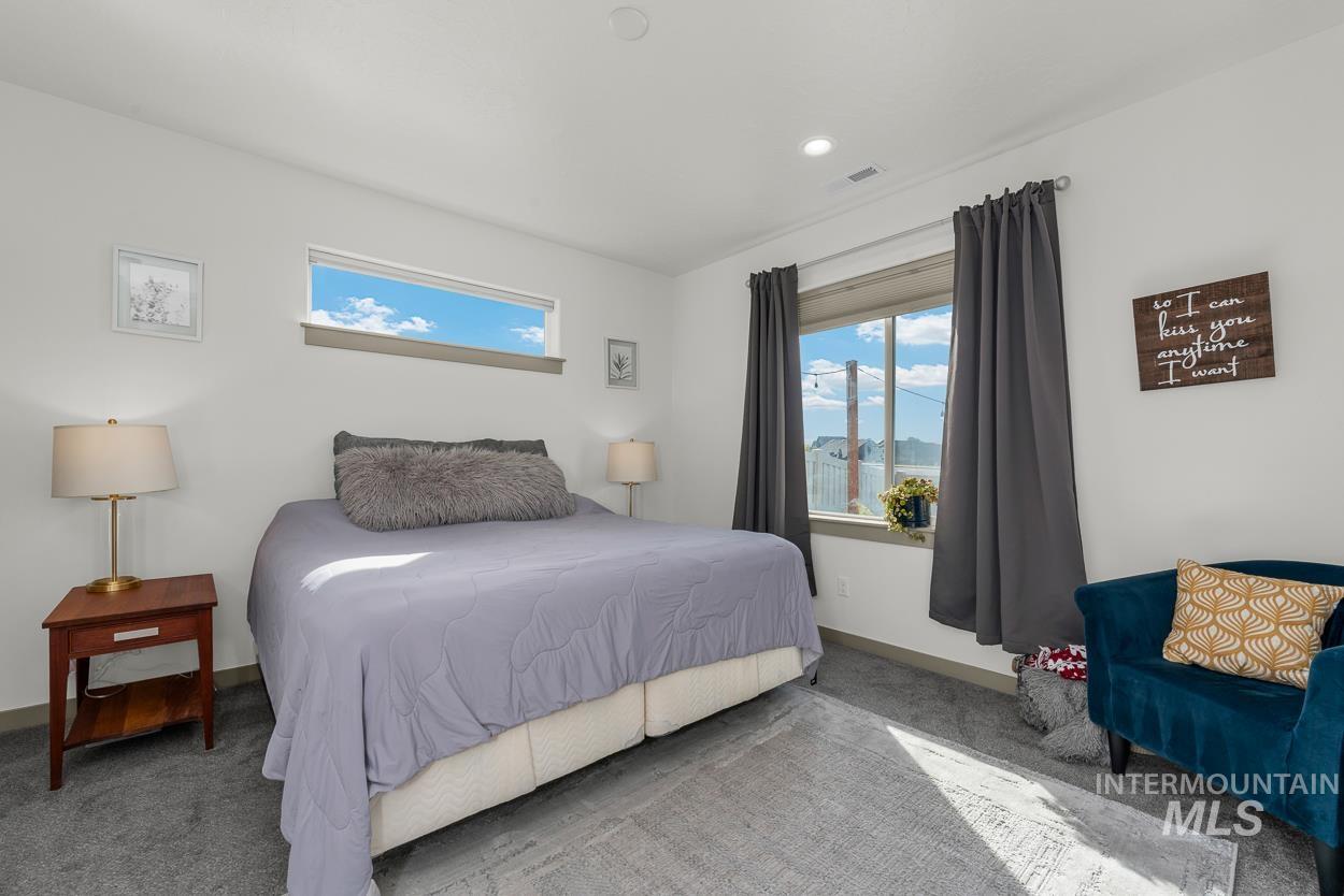 Carpeted bedroom featuring baseboards and recessed lighting
