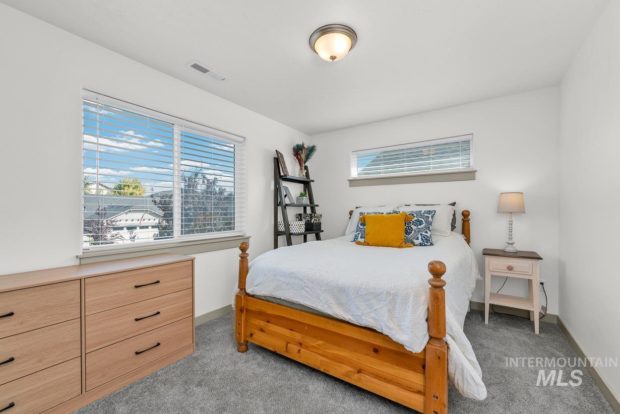 Bedroom with light carpet and baseboards