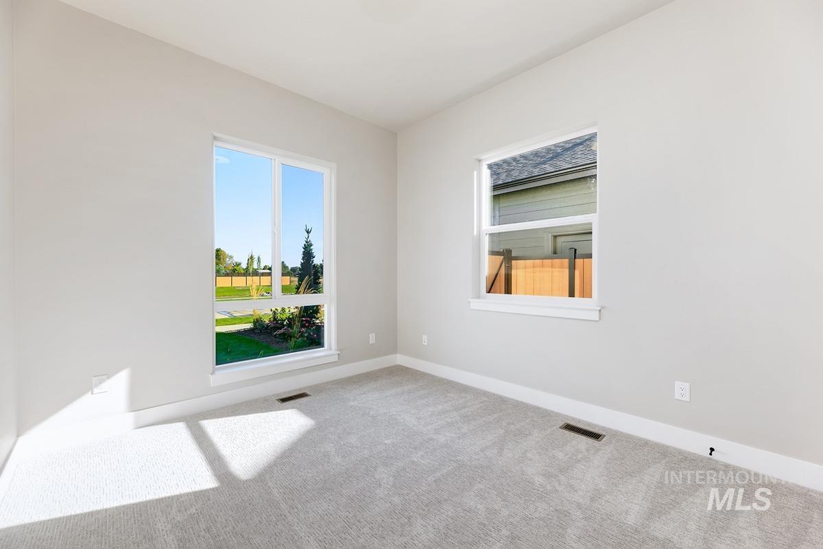 Carpeted empty room featuring baseboards