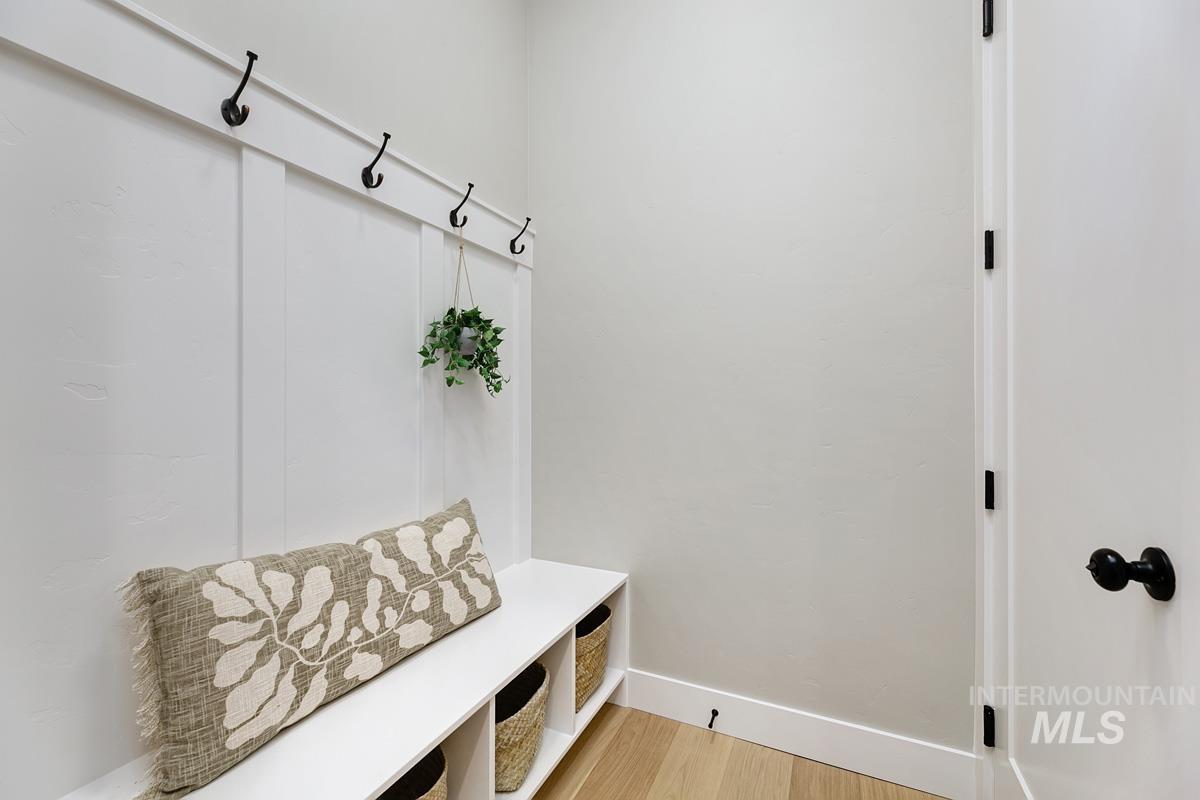 Mudroom with light wood-style floors and baseboards