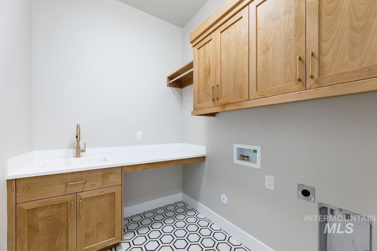 Laundry area featuring washer hookup, hookup for an electric dryer, and cabinet space