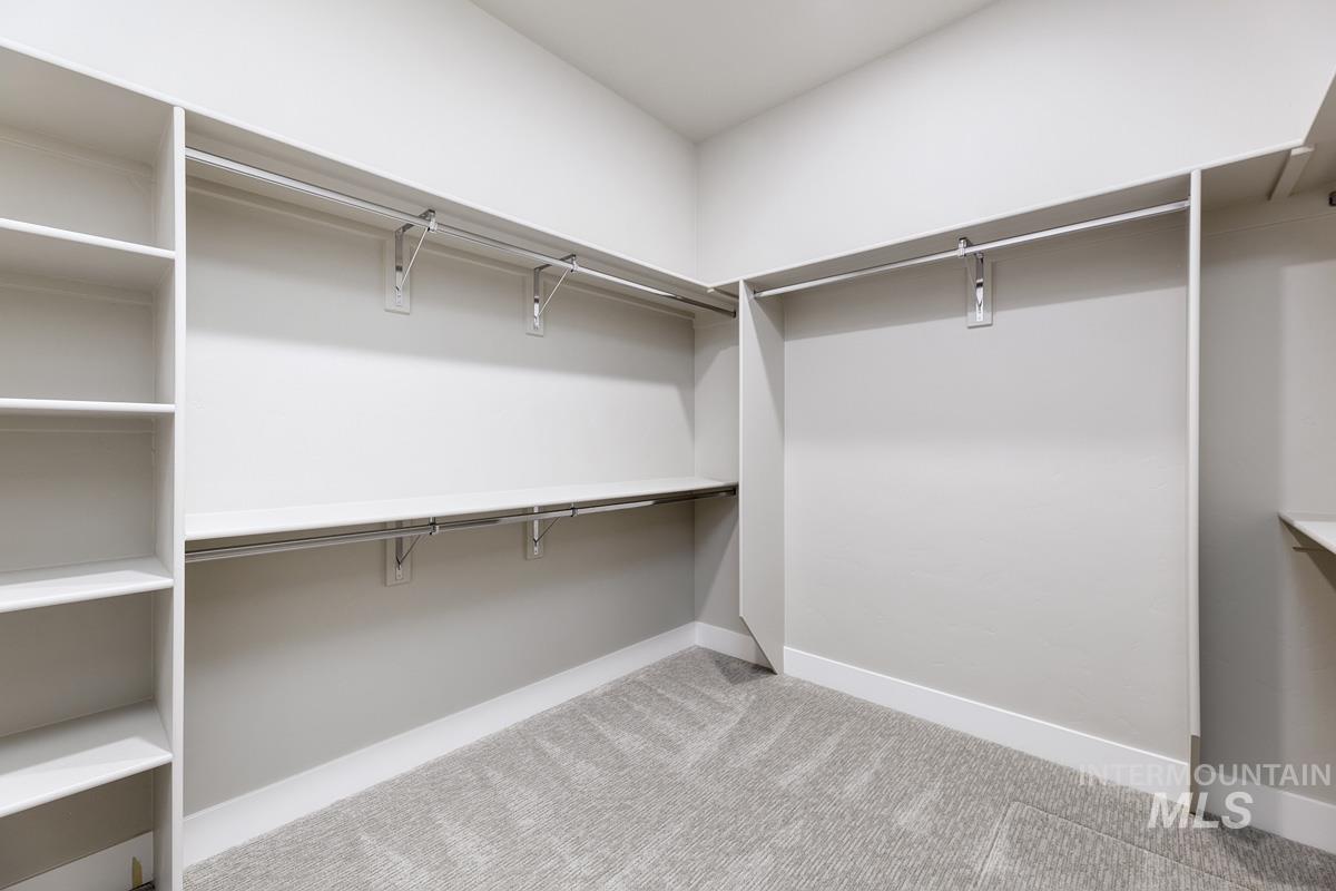 Spacious closet with light carpet