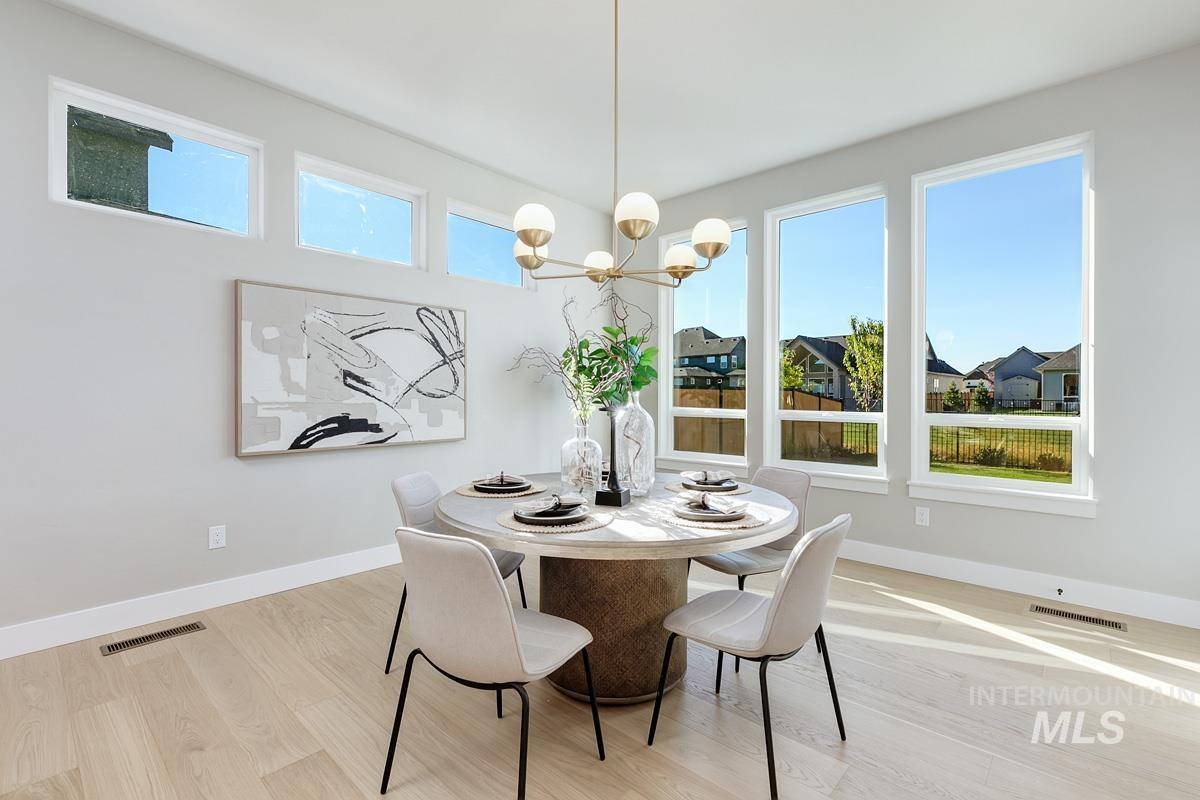 Dining area with light wood finished floors and a chandelier