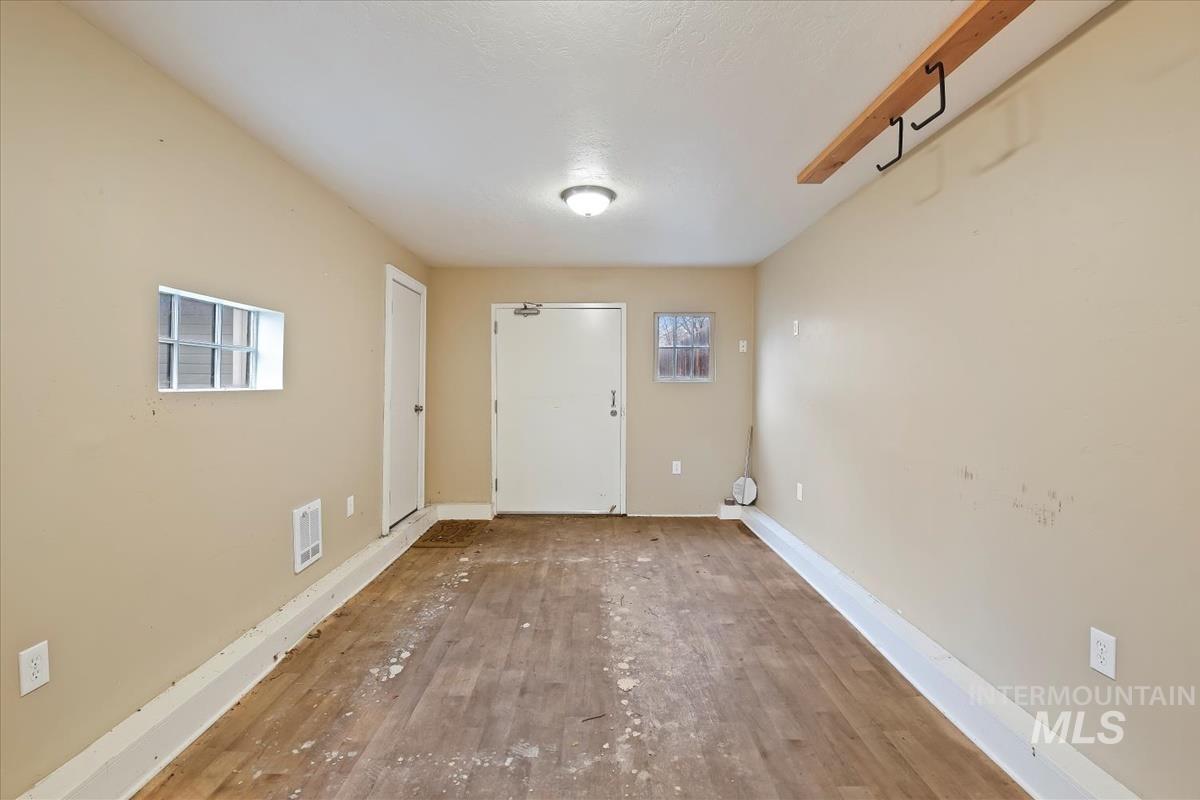 Entryway featuring hardwood / wood-style floors and baseboards