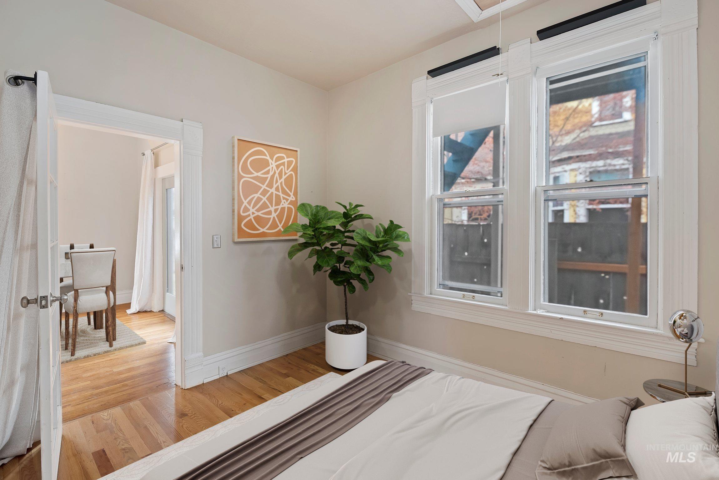 Bedroom with light wood-style flooring and attic access