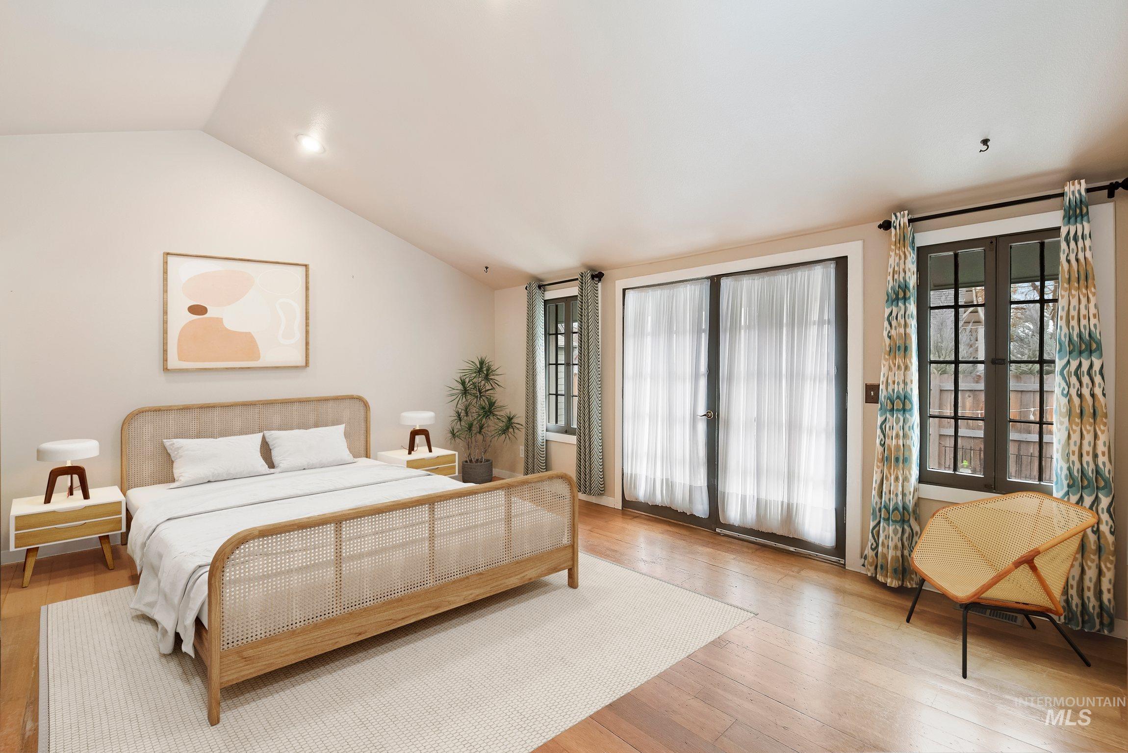 Bedroom with vaulted ceiling, wood-type flooring, and access to outside