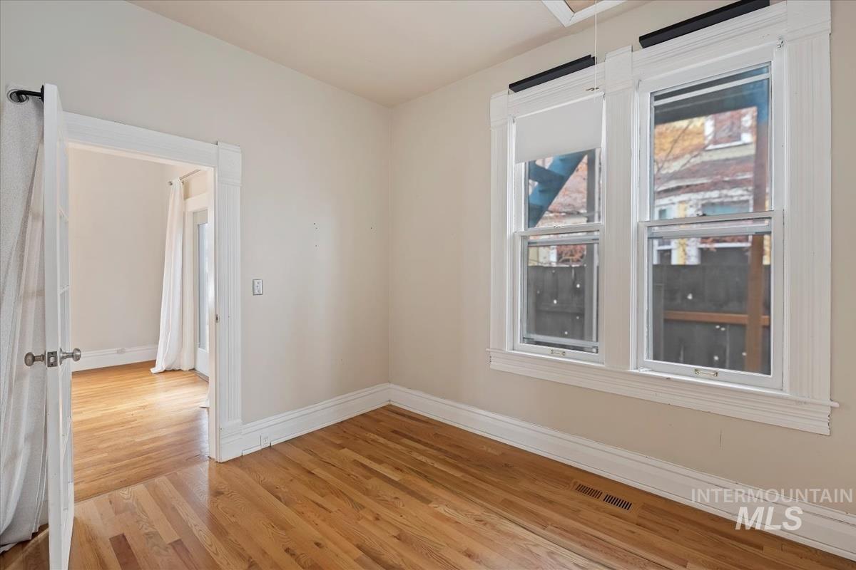 Spare room featuring attic access and light wood-style flooring