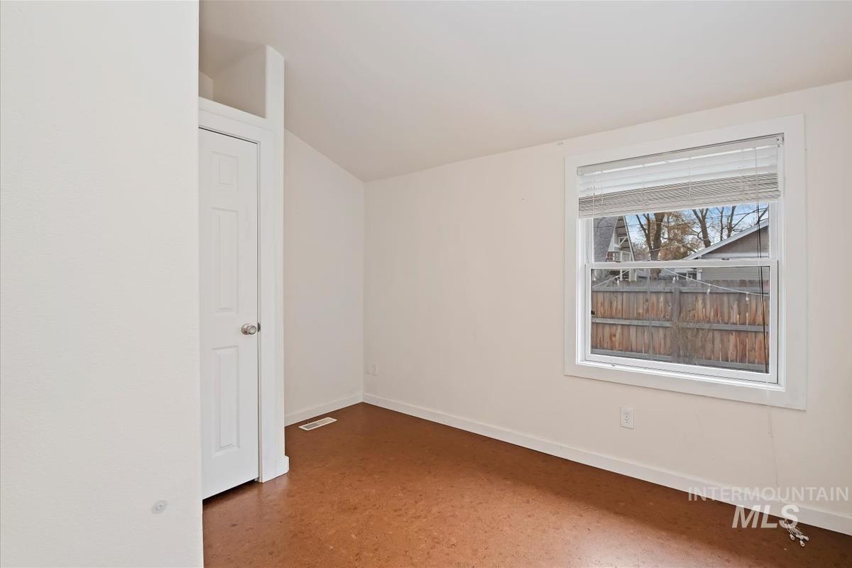 Bonus room with baseboards and vaulted ceiling