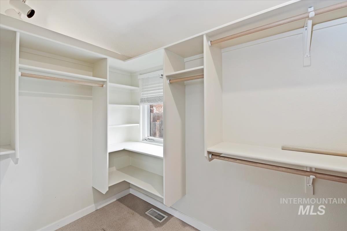 Spacious closet with carpet