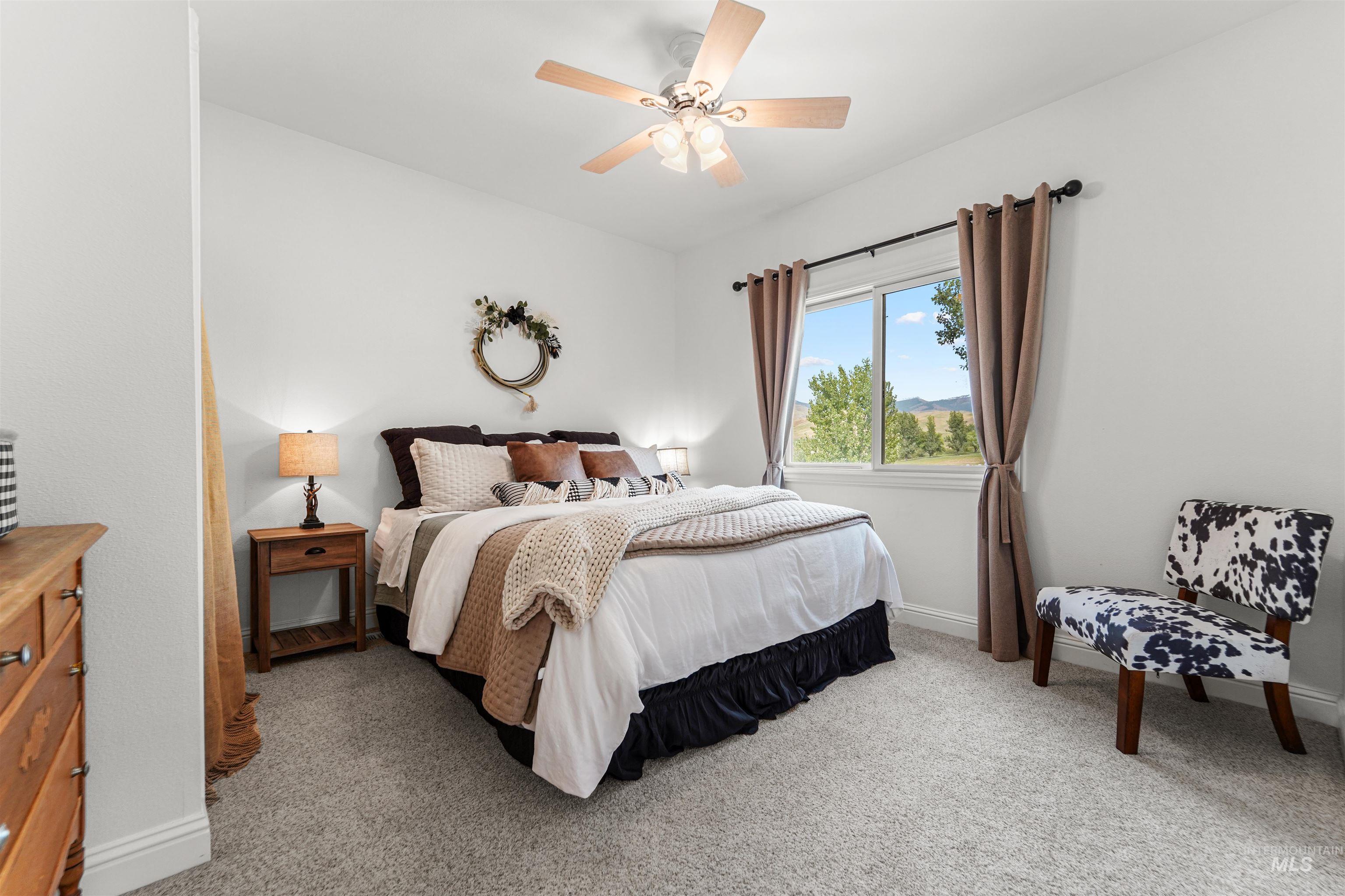 Bedroom featuring light colored carpet and ceiling fan