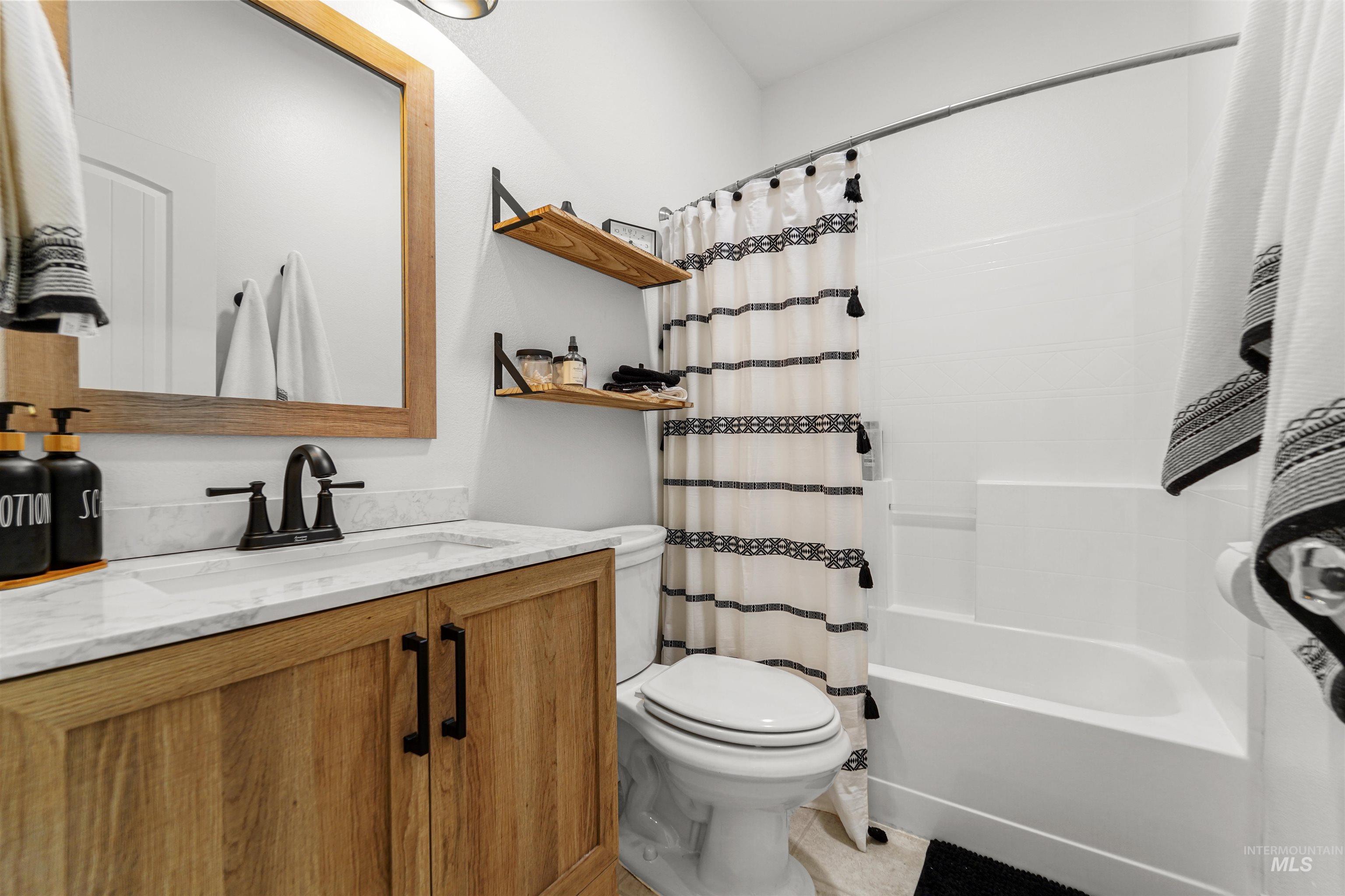 Full bathroom with vanity and shower / tub combo