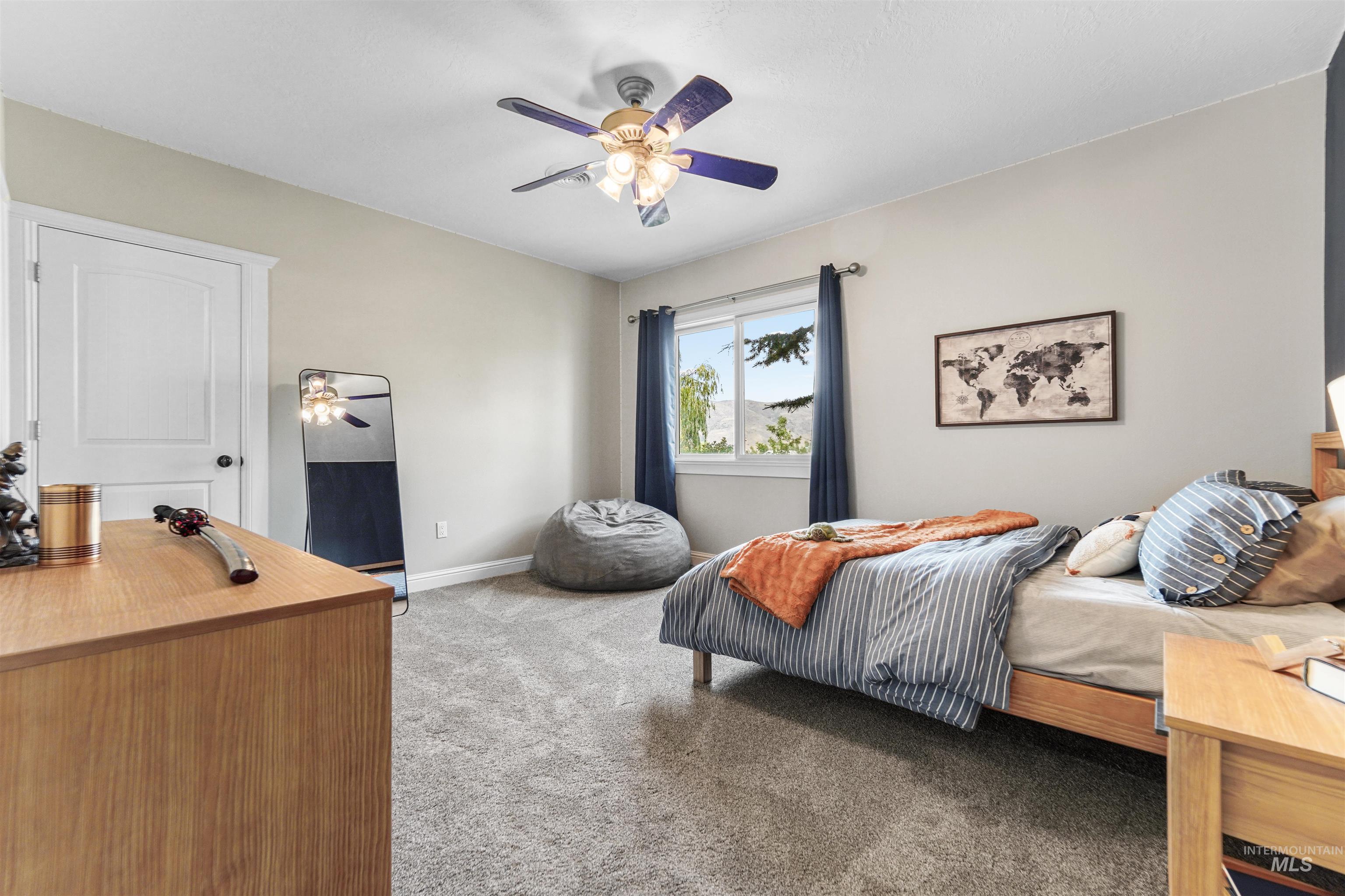 Bedroom featuring light colored carpet and ceiling fan