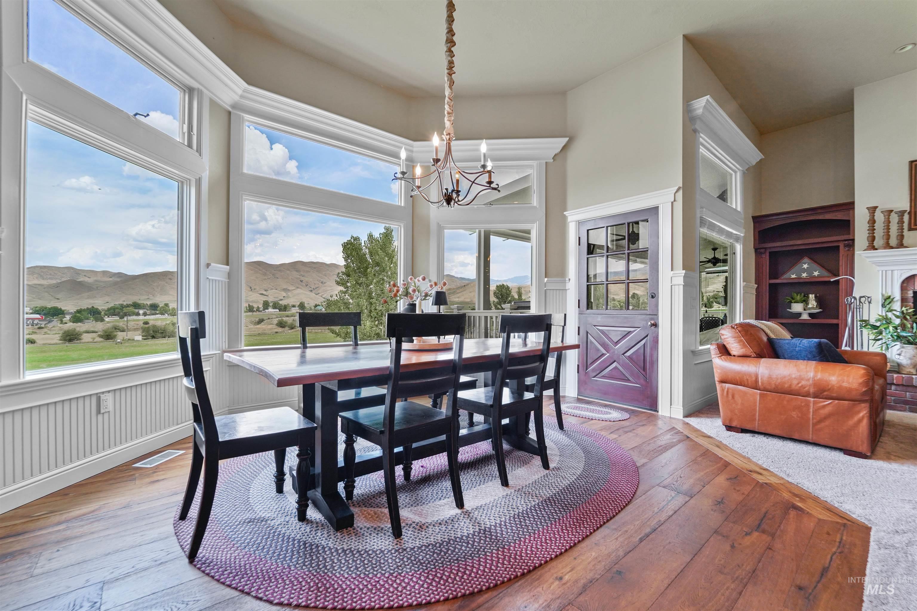 Dining space featuring a mountain view, light wood-style floors, and a chandelier