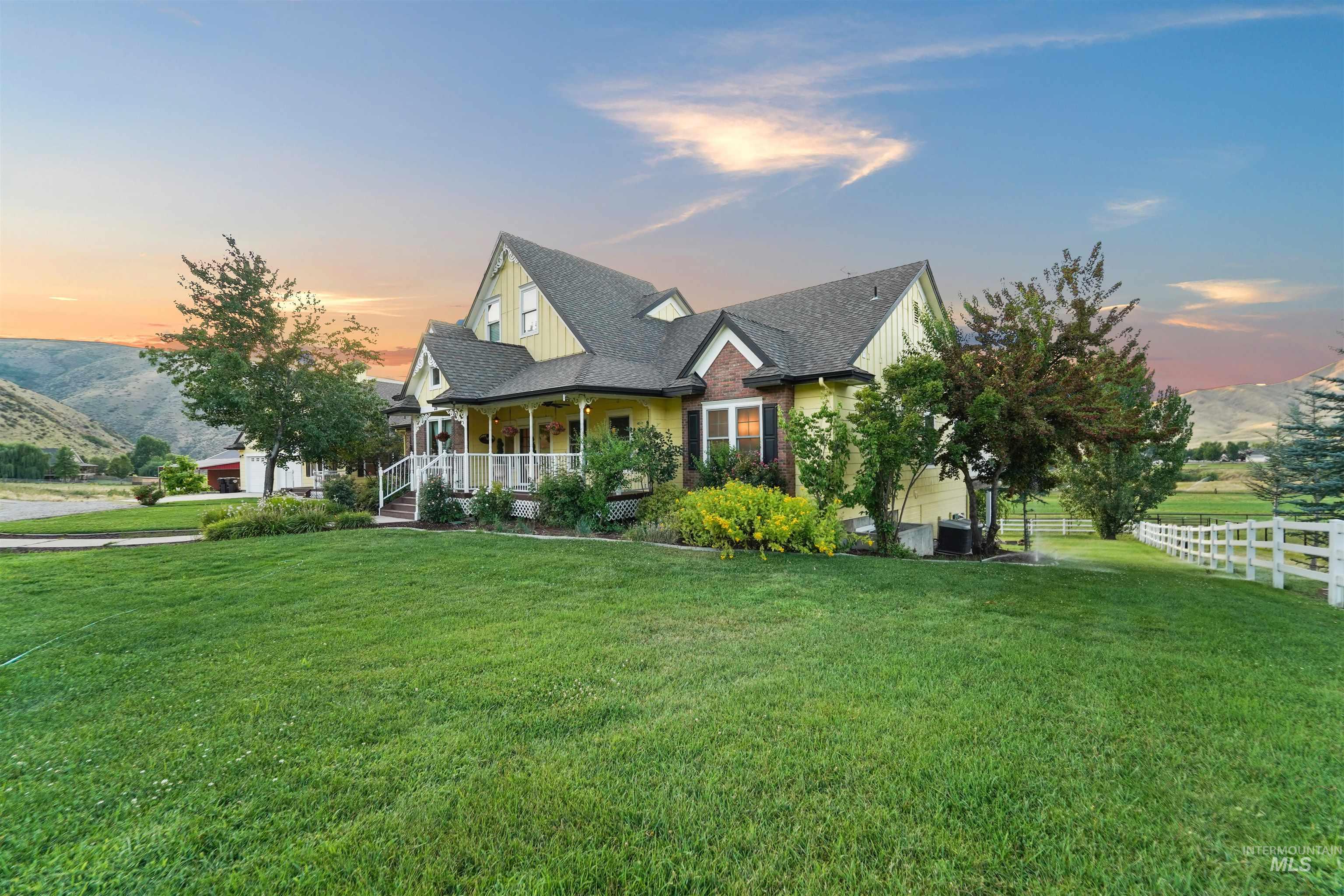 View of front of home with a mountain view, covered porch, roof with shingles, and board and batten siding